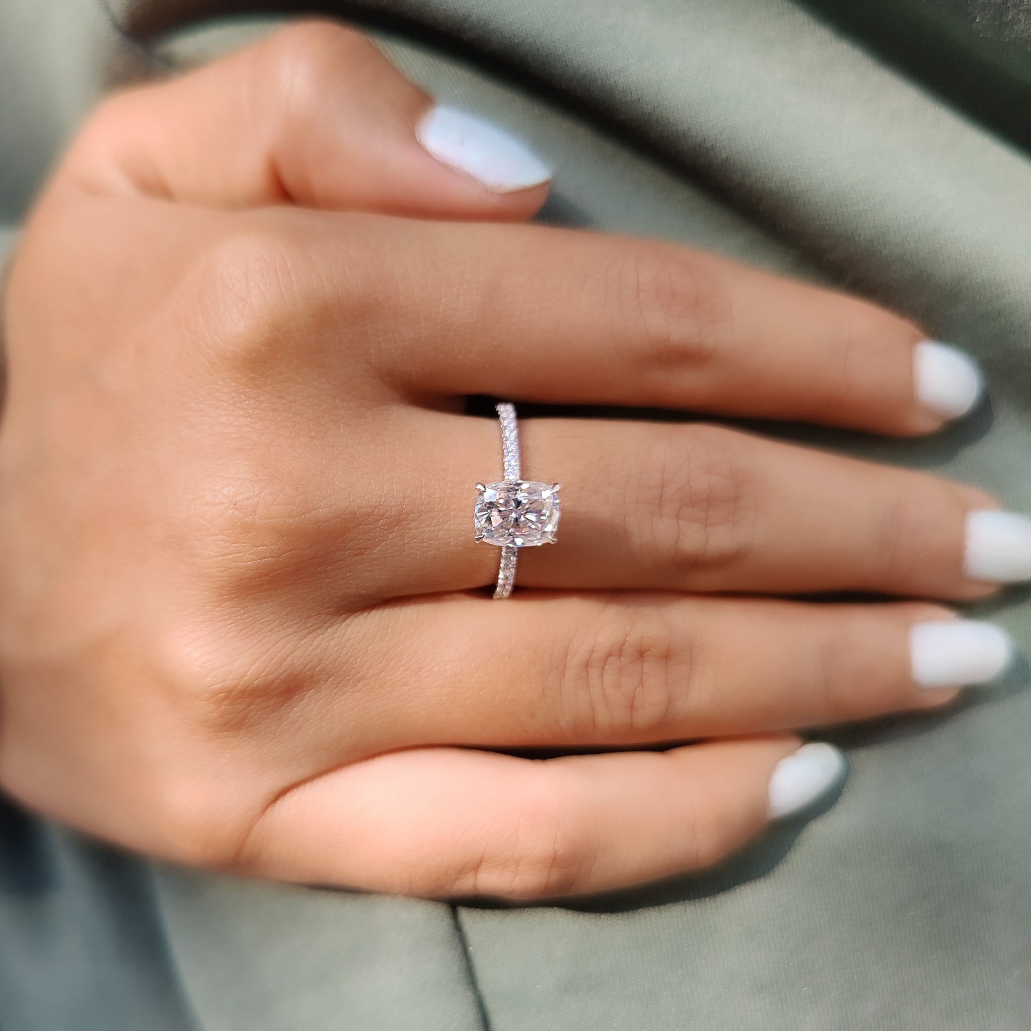 Four claw prong set cushion cut moissanite ring.