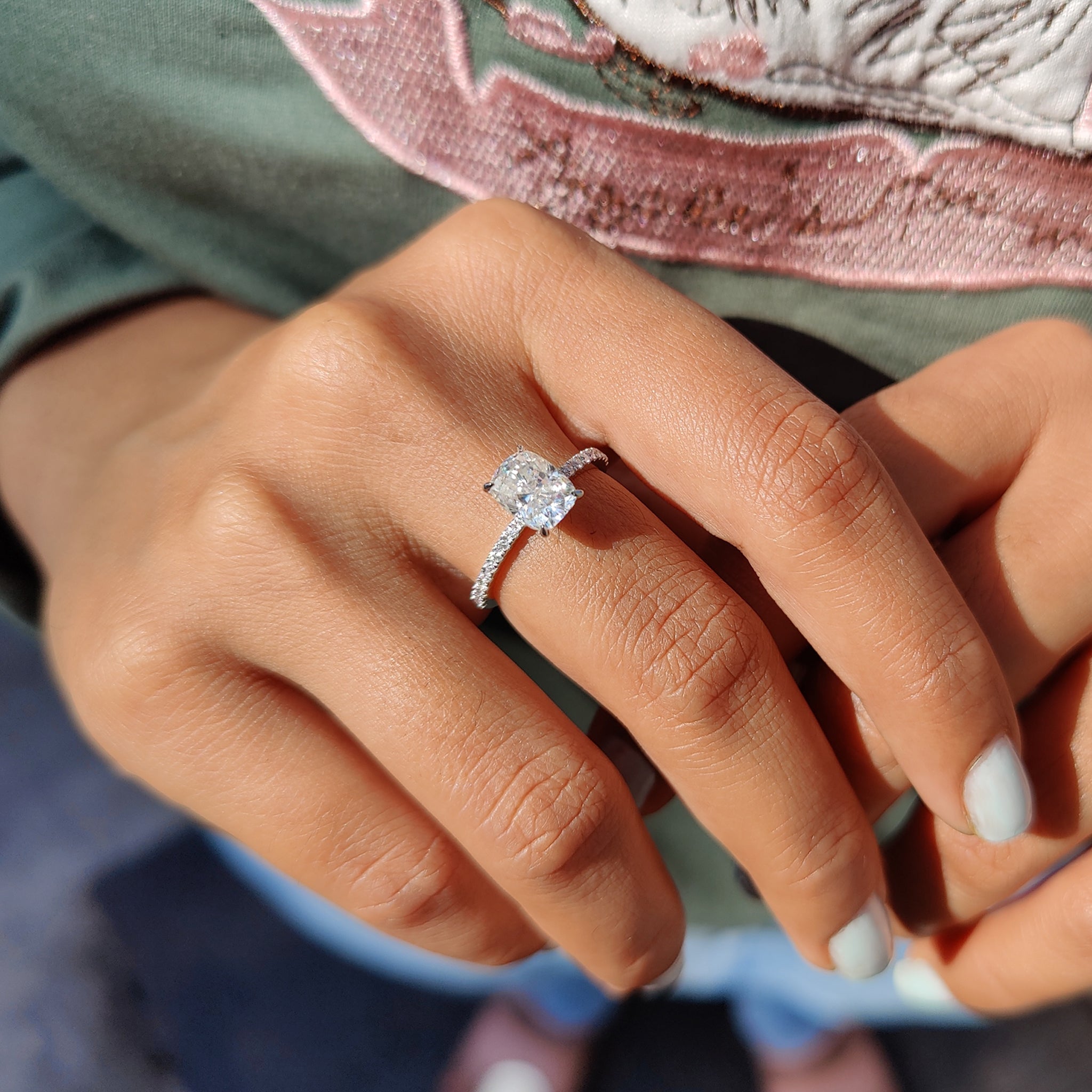 Claw prong setting ring with round pave diamonds.
