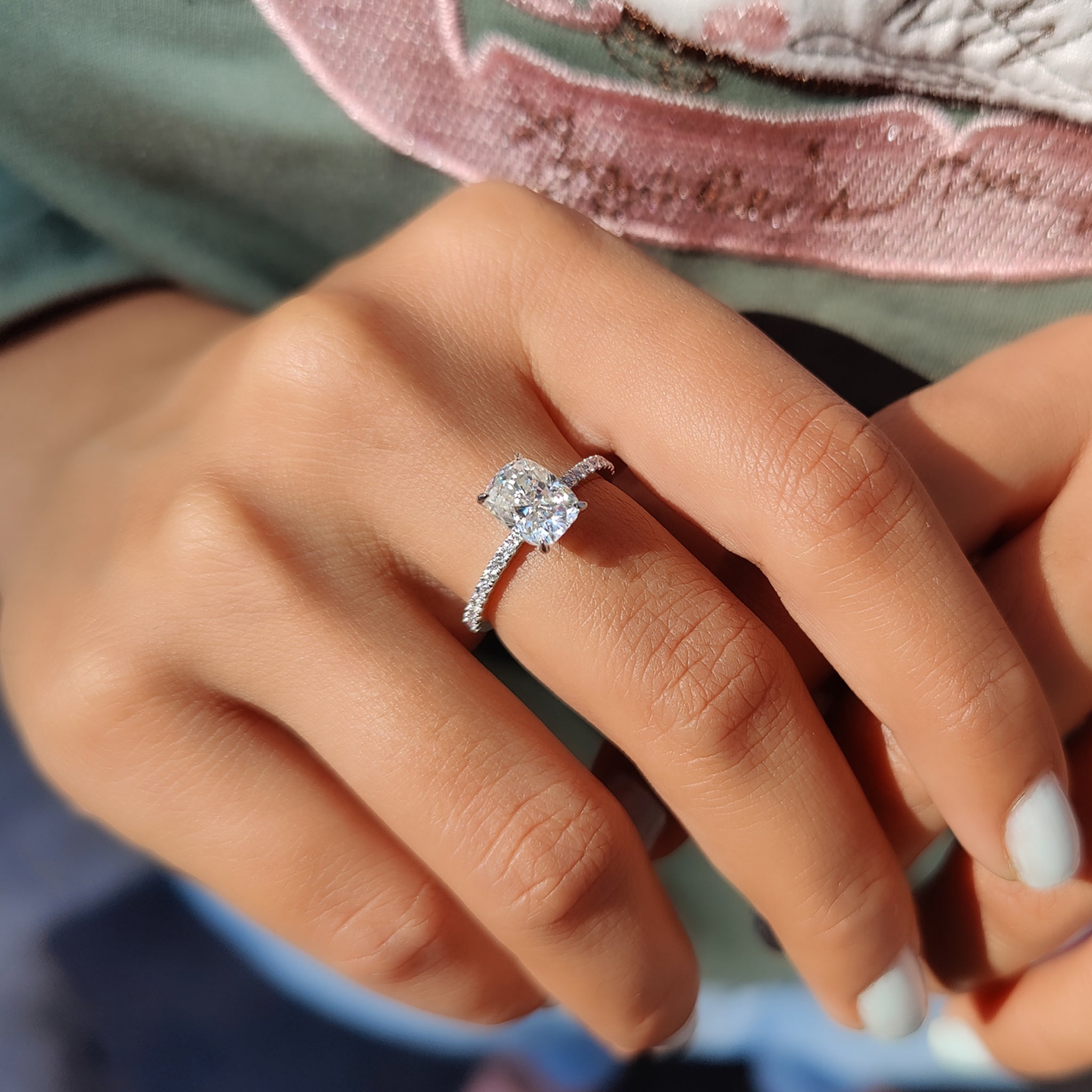 Prong setting engagement ring with cushion cut center.
