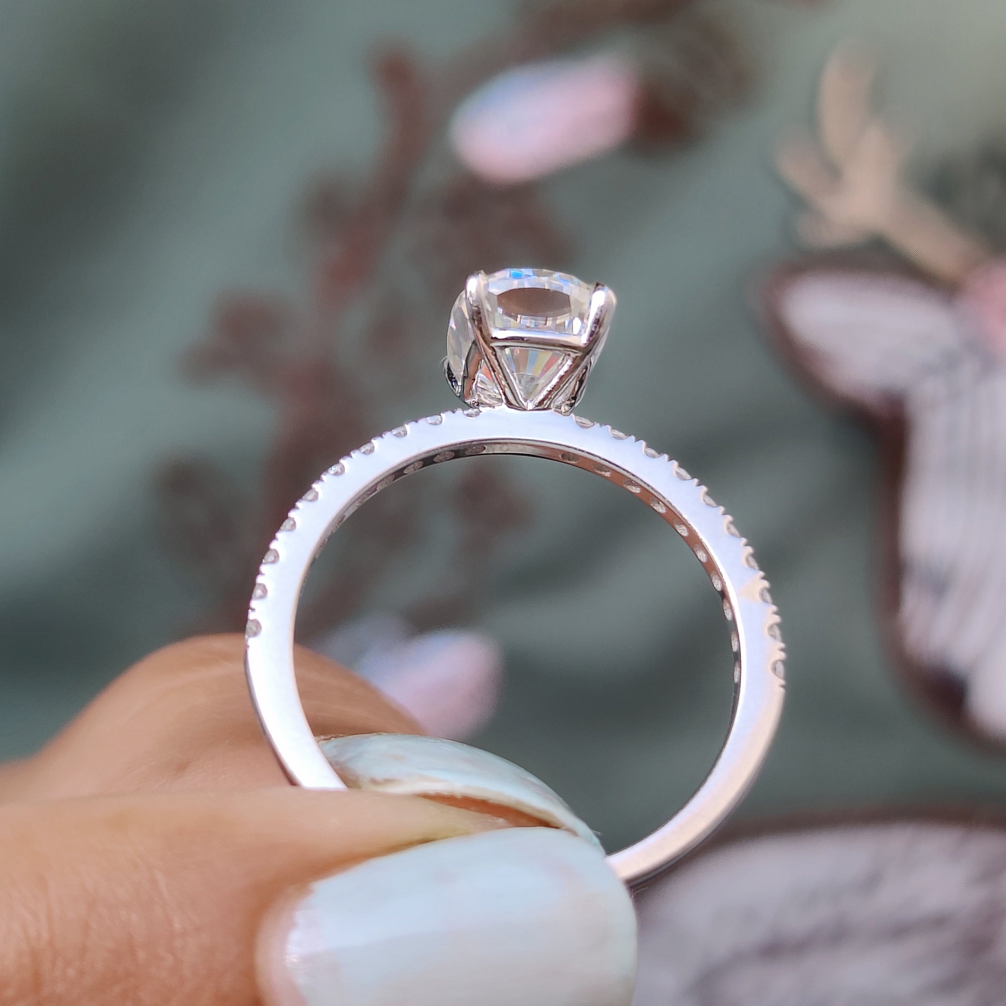 Claw prong setting ring with round pave diamonds.