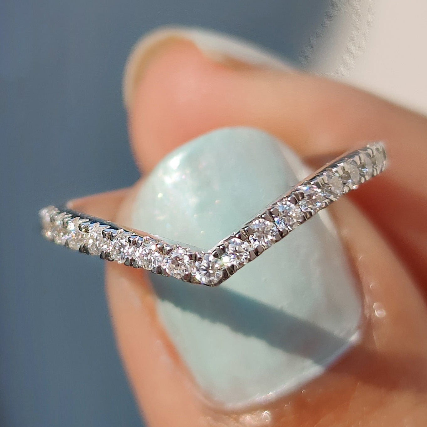 V shaped wedding band with moissanite stones.
