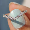 V shaped wedding band with moissanite stones.
