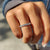 Moissanite wedding band in a handmade band design.