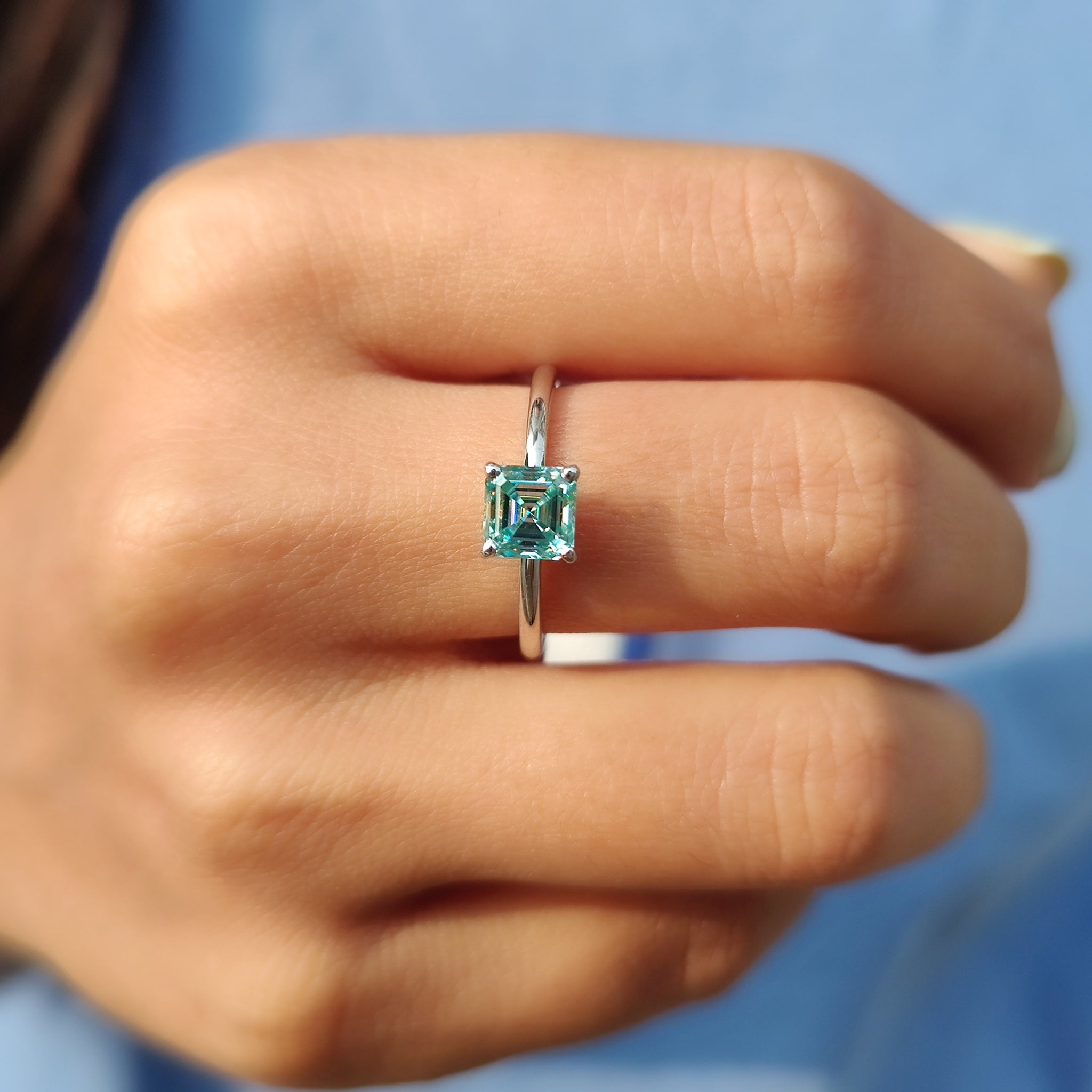 Solitaire moissanite ring set in white gold.