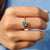 Solitaire moissanite ring set in white gold.