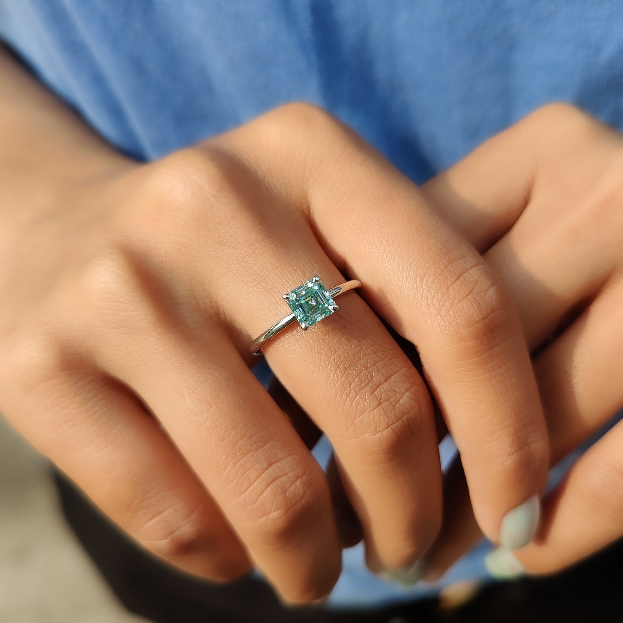 Cyan blue moissanite ring with a radiant sparkle.