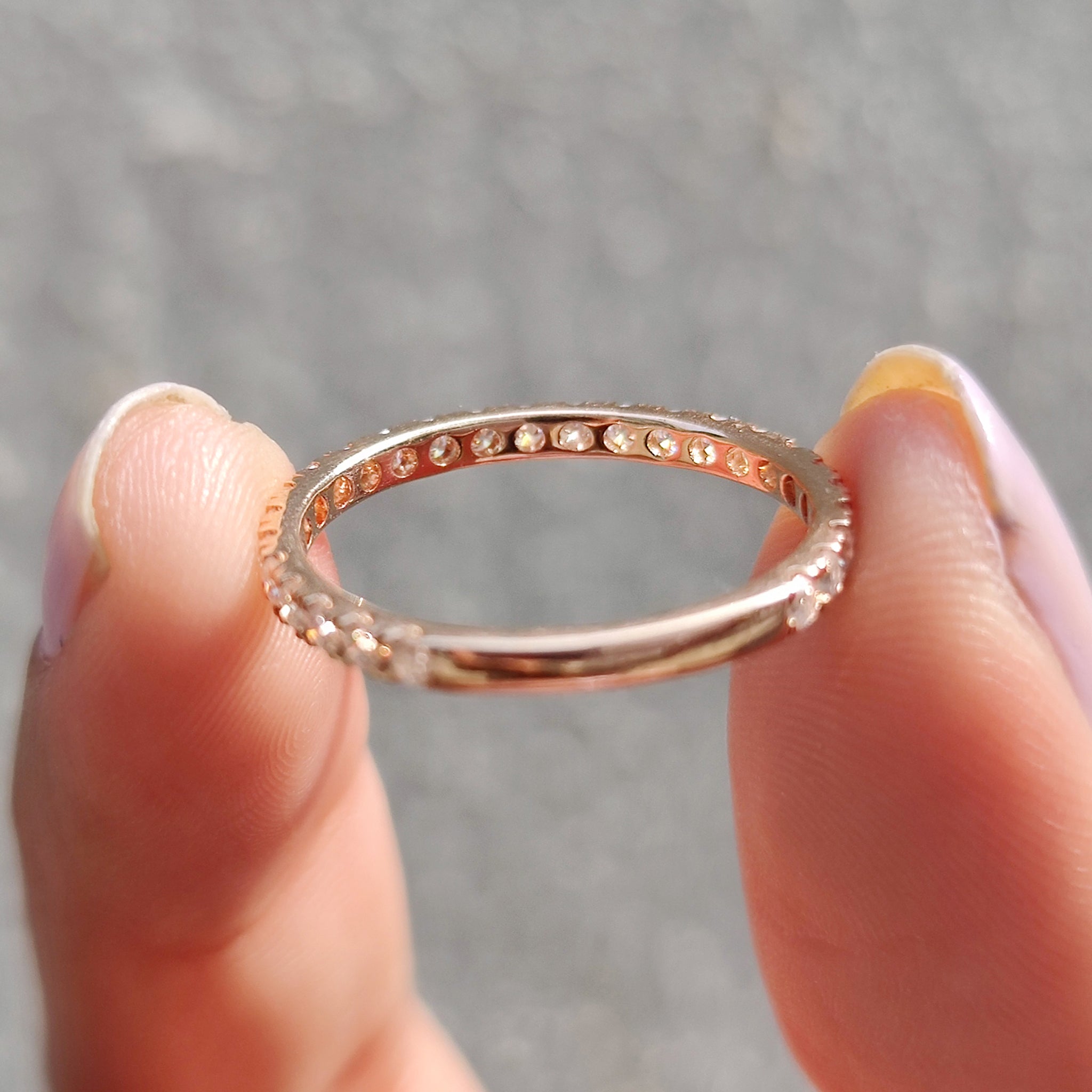 A round moissanite wedding band and rose gold moissanite band bring out sophistication.