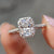 Radiant cut moissanite ring with a halo setting in white gold.