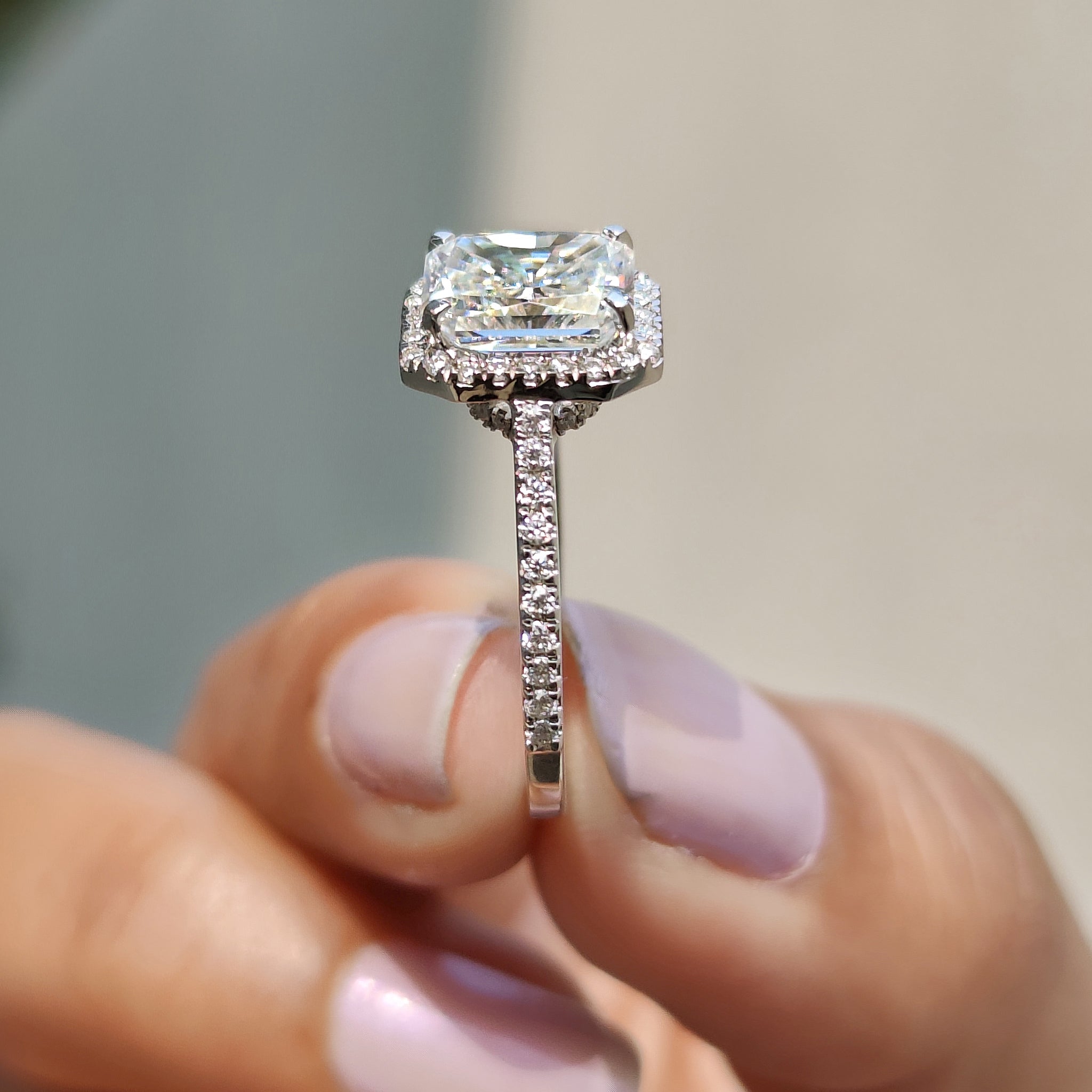 Hidden halo radiant cut moissanite ring in a white gold setting.