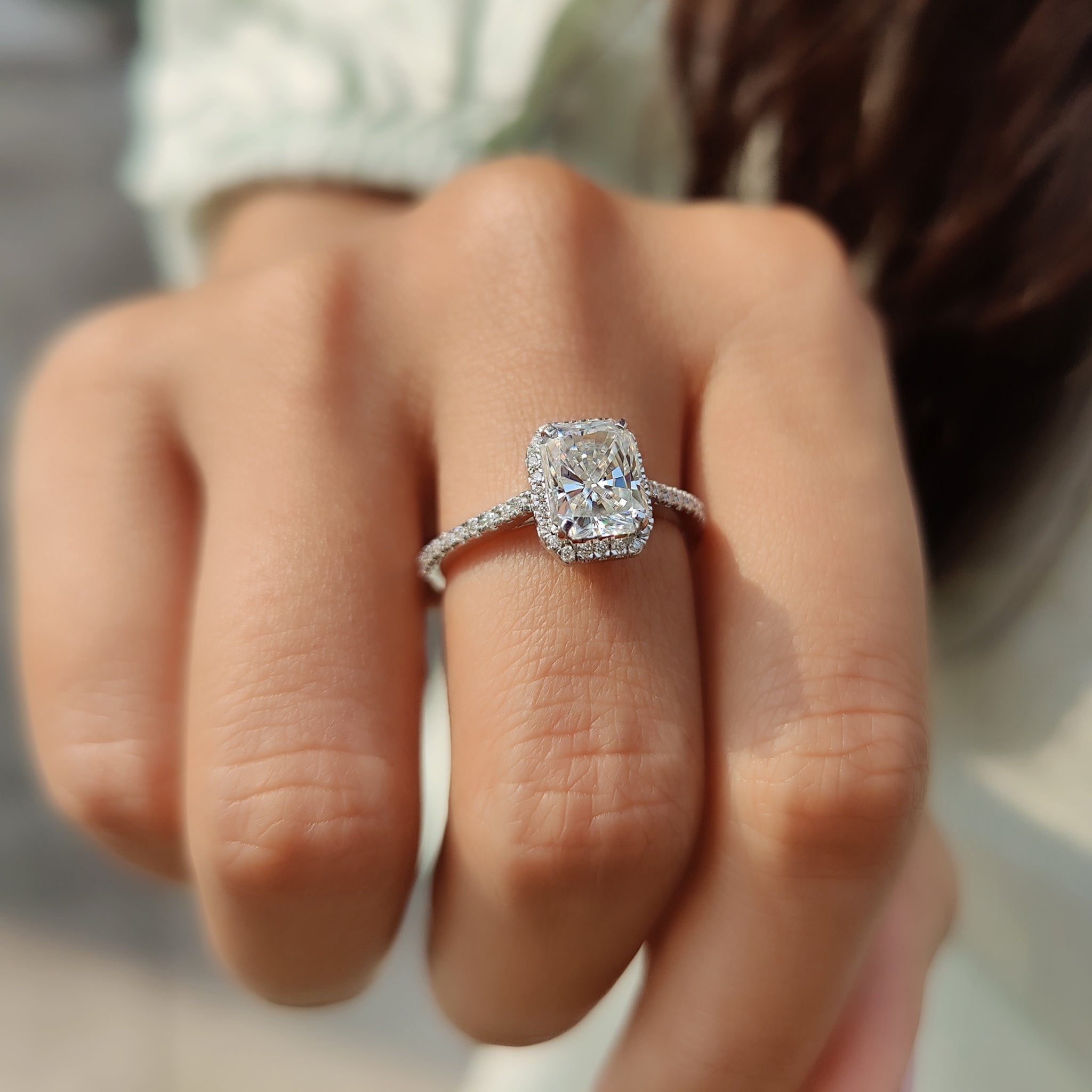 Carat Diamonds radiant cut moissanite ring with a timeless halo design.
