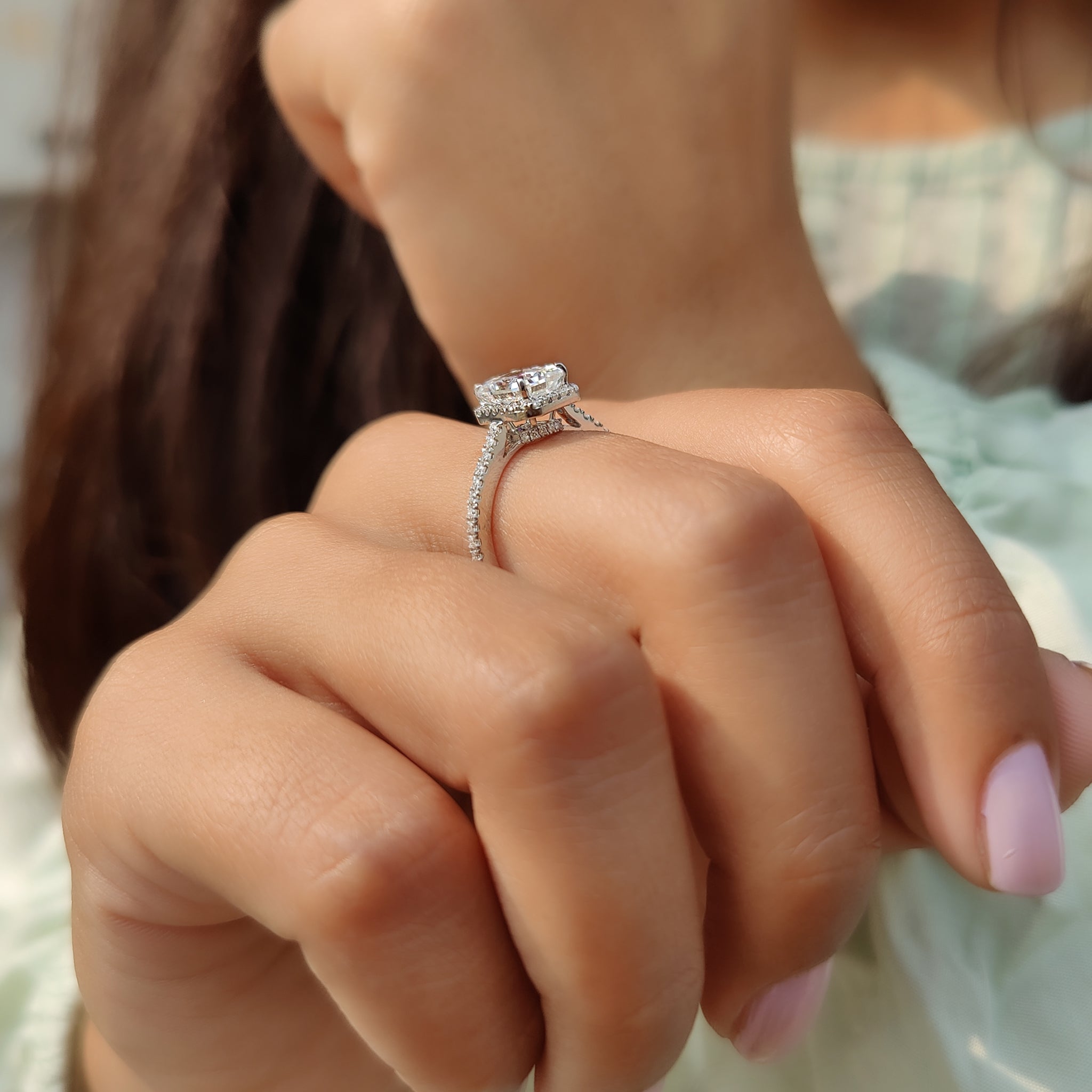Carat Diamonds handmade engagement ring with a radiant cut center stone.