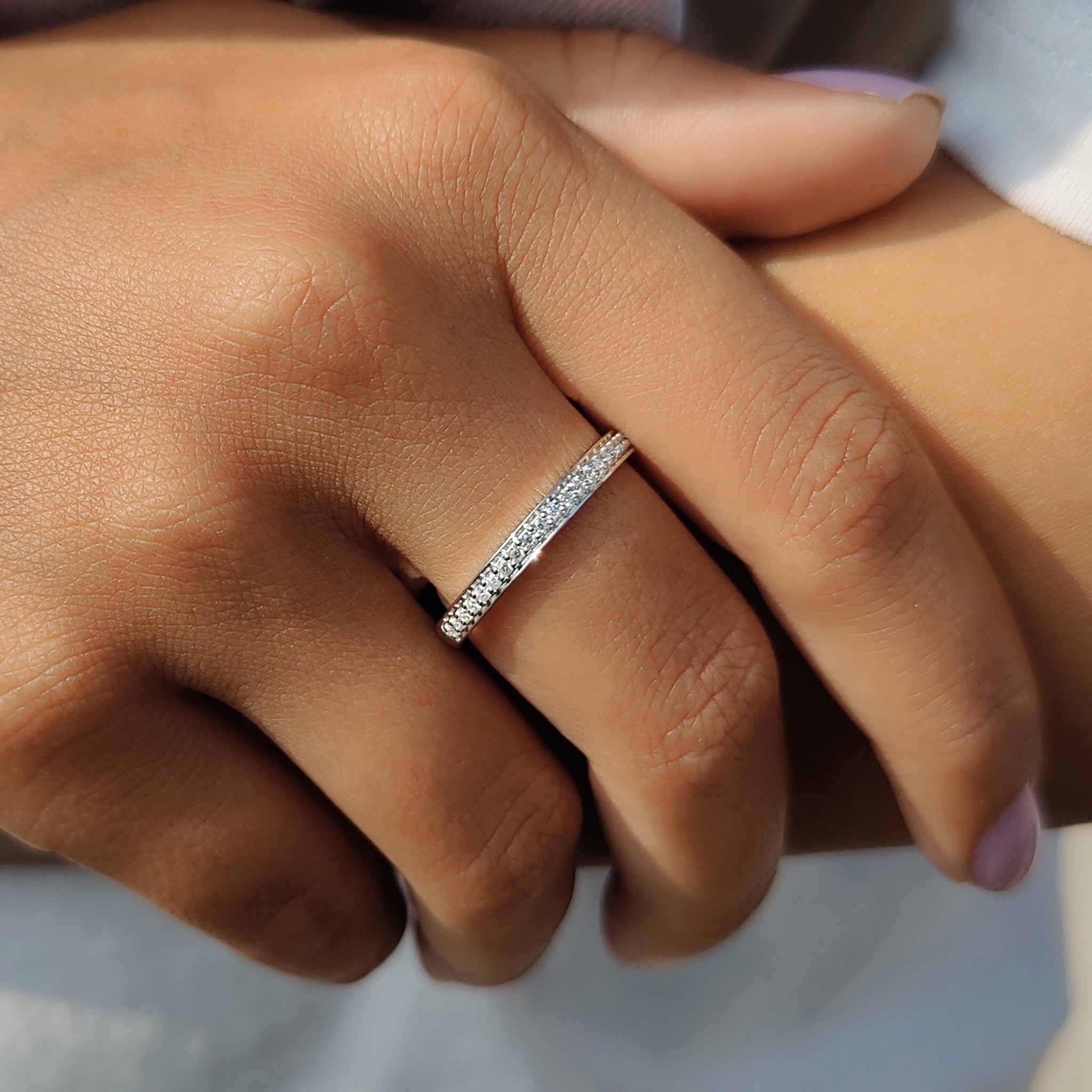 Moissanite wedding band white gold with round moissanite stones.