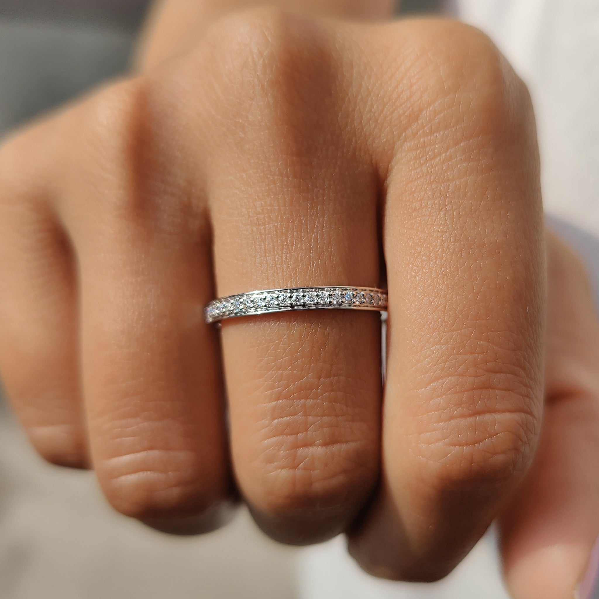 Custom wedding band crafted with round moissanite stones.