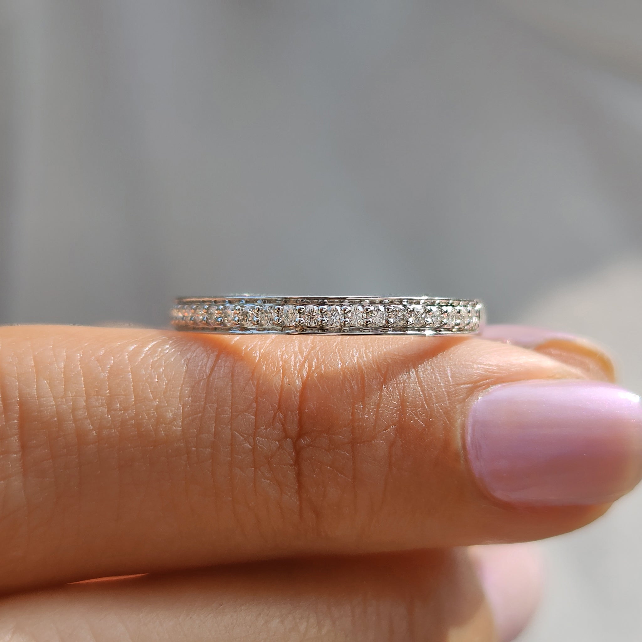 Buy moissanite band featuring prong set round moissanite stones.