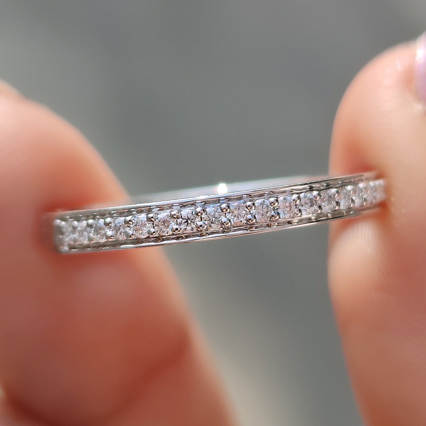 Handmade band in white gold with half eternity moissanite setting.