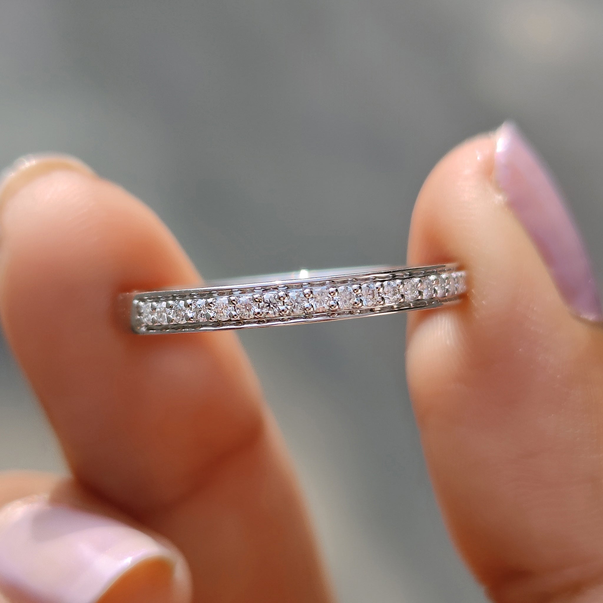 Handmade jewelry featuring a moissanite wedding band design.