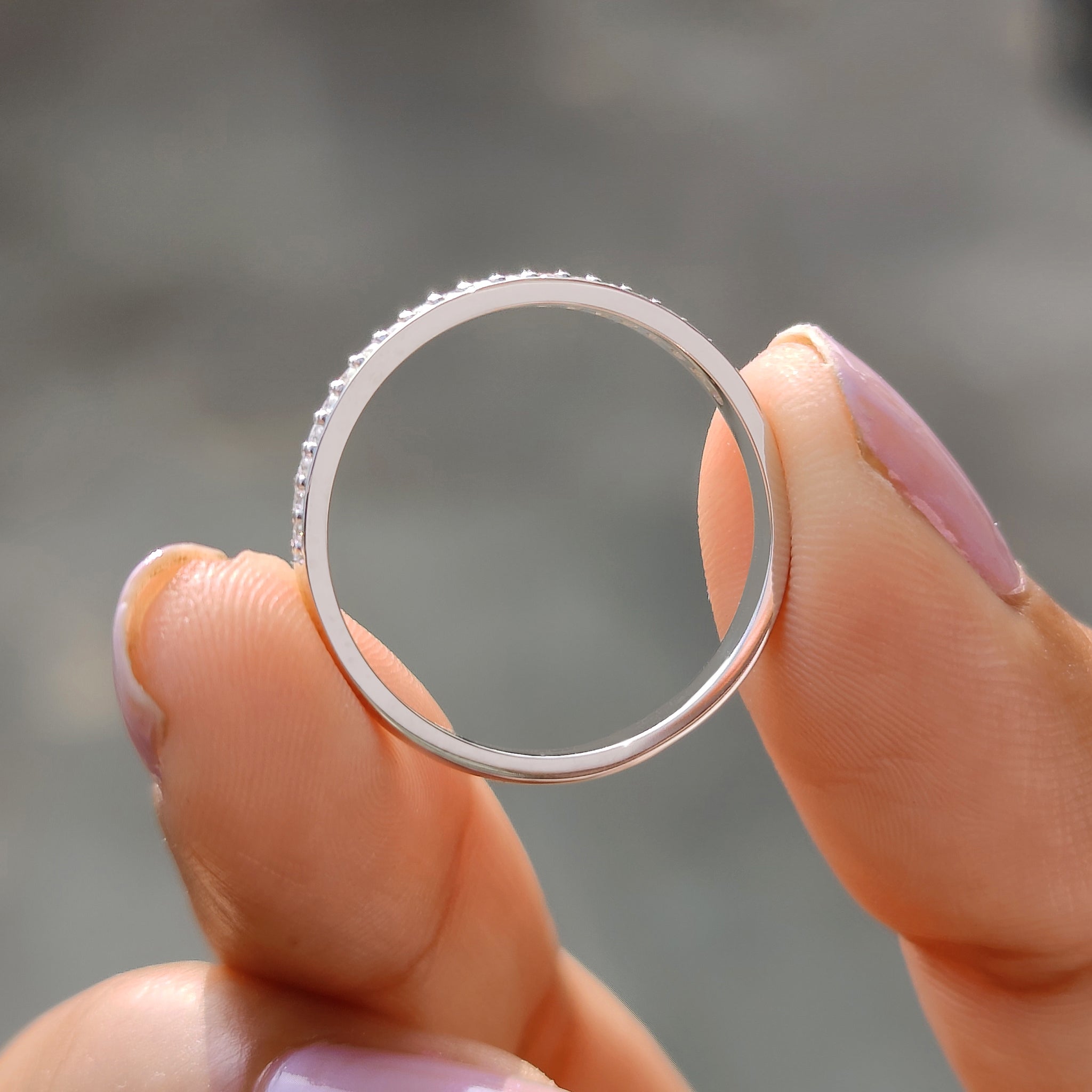 Carat Diamonds band in white gold with a prong set wedding style.