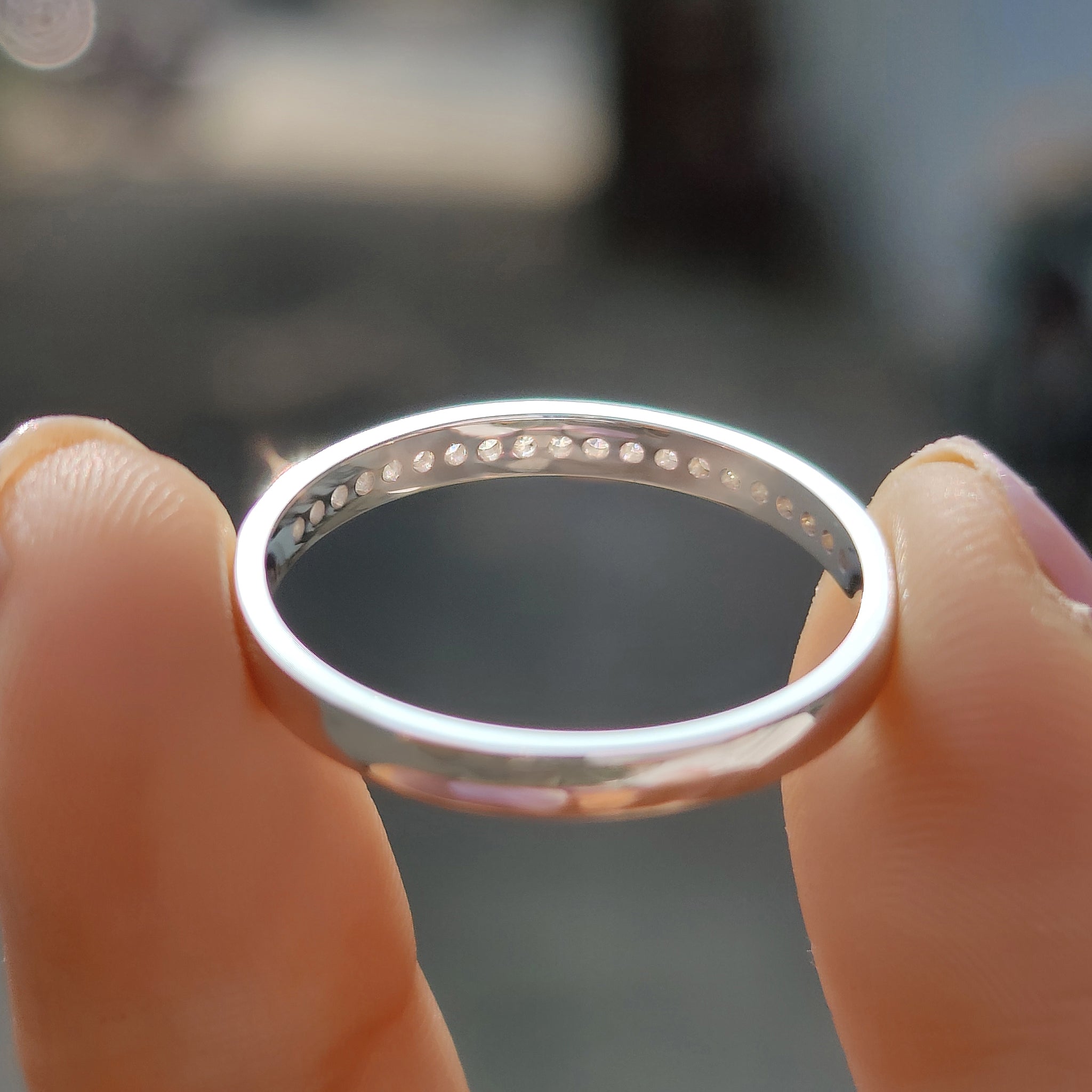 Carat Diamonds wedding band featuring round moissanite stones.