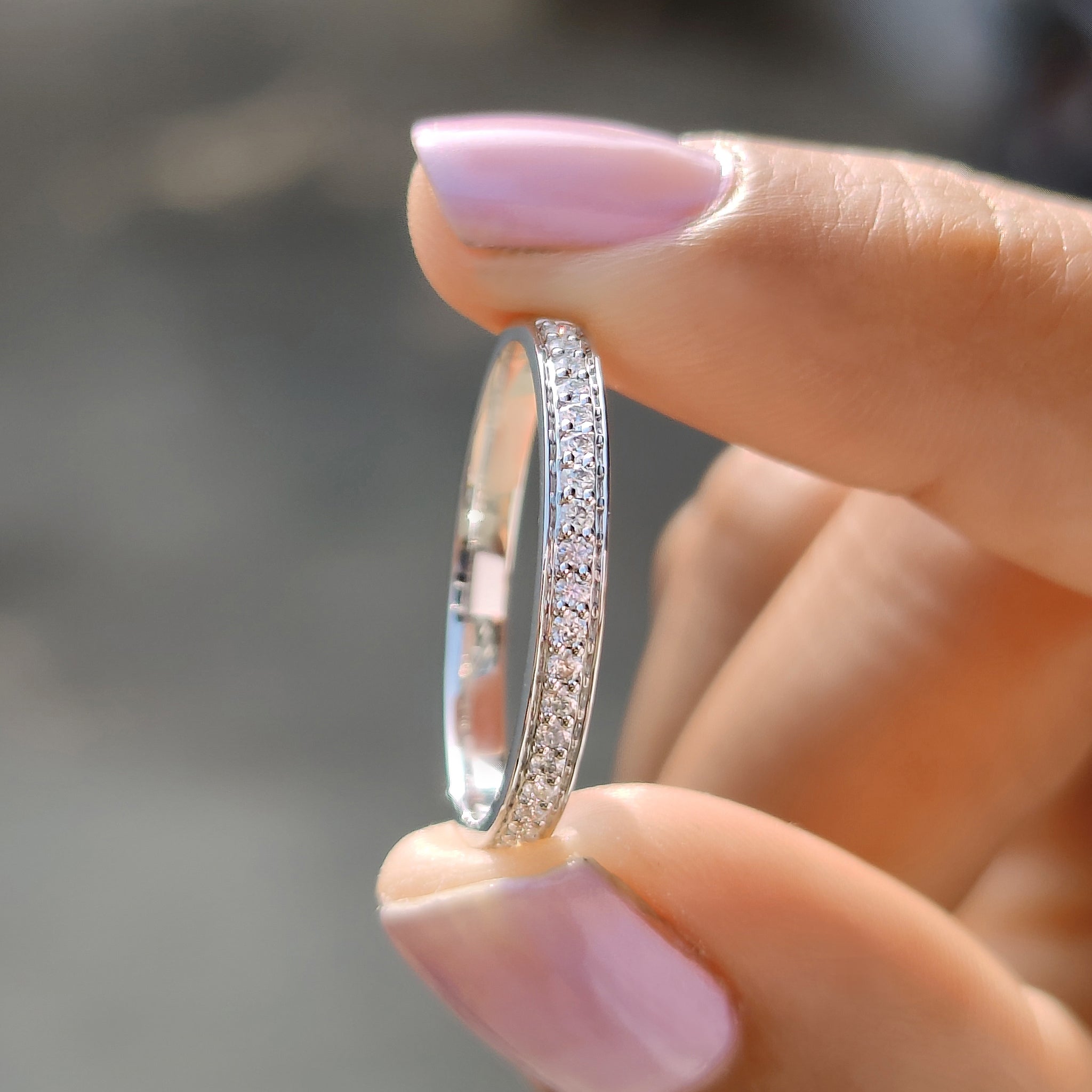 Moissanite wedding band white gold with prong set half eternity style.