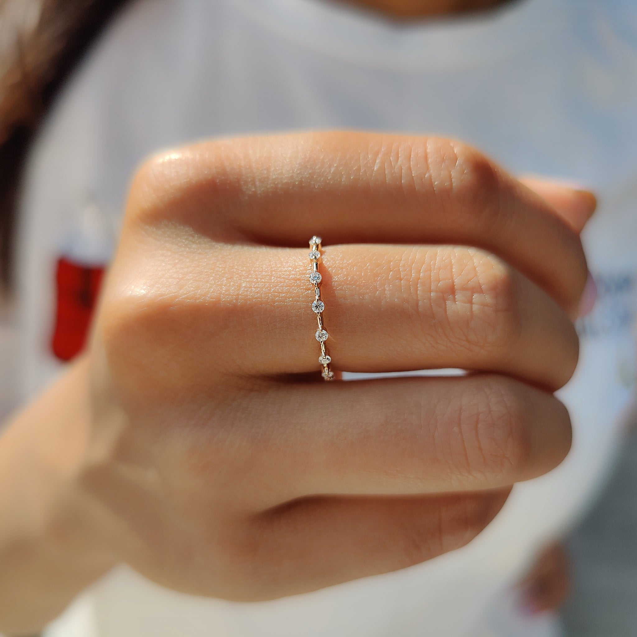 Moissanite stackable wedding band with sparkling details.