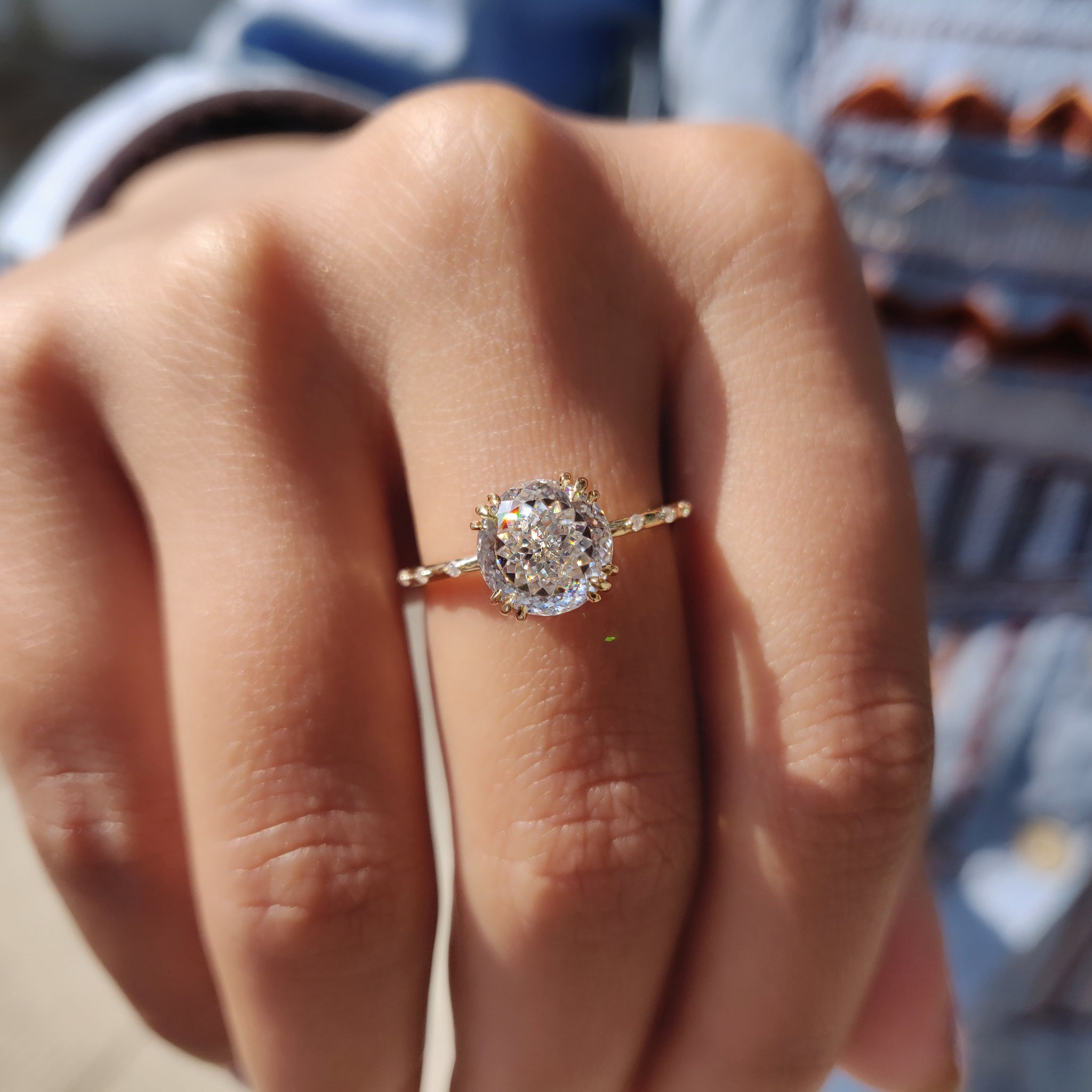 The white gold ring complements the moissanite's brilliance.
