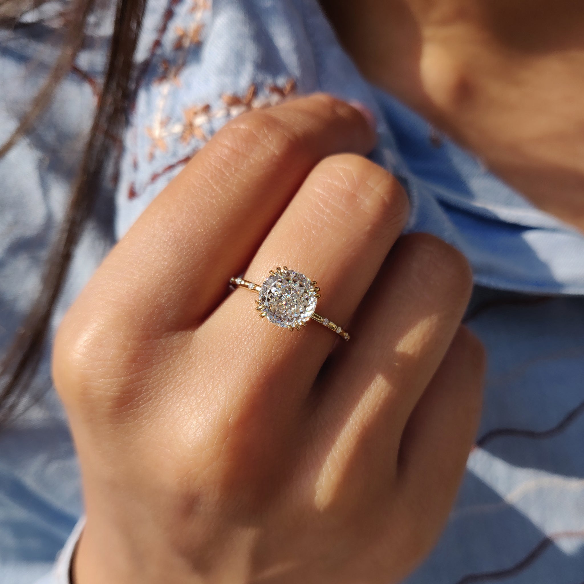 A Portuguese round moissanite ring sparkles with refined beauty.