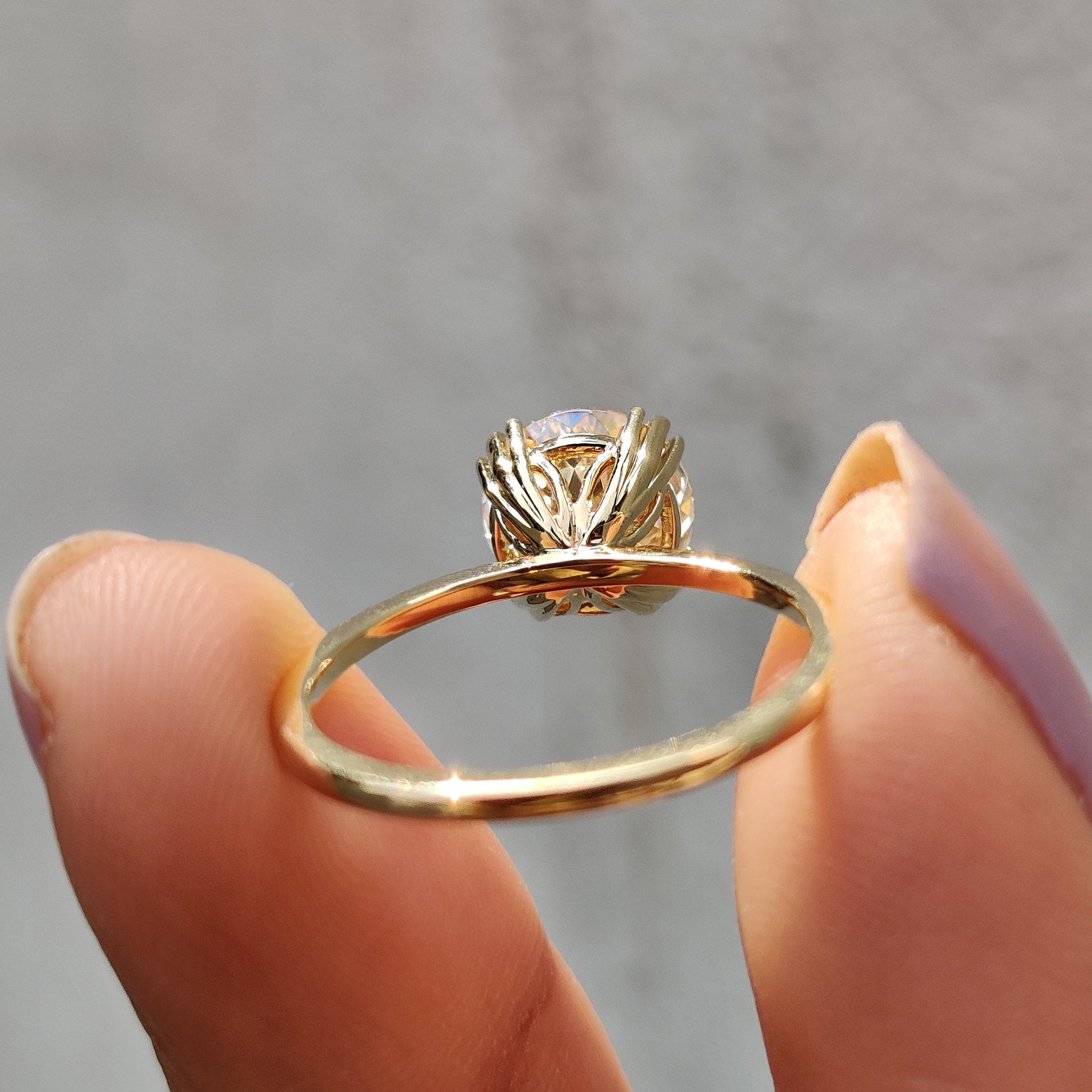 Moissanite engagement ring displayed on a hand with subtle shine
