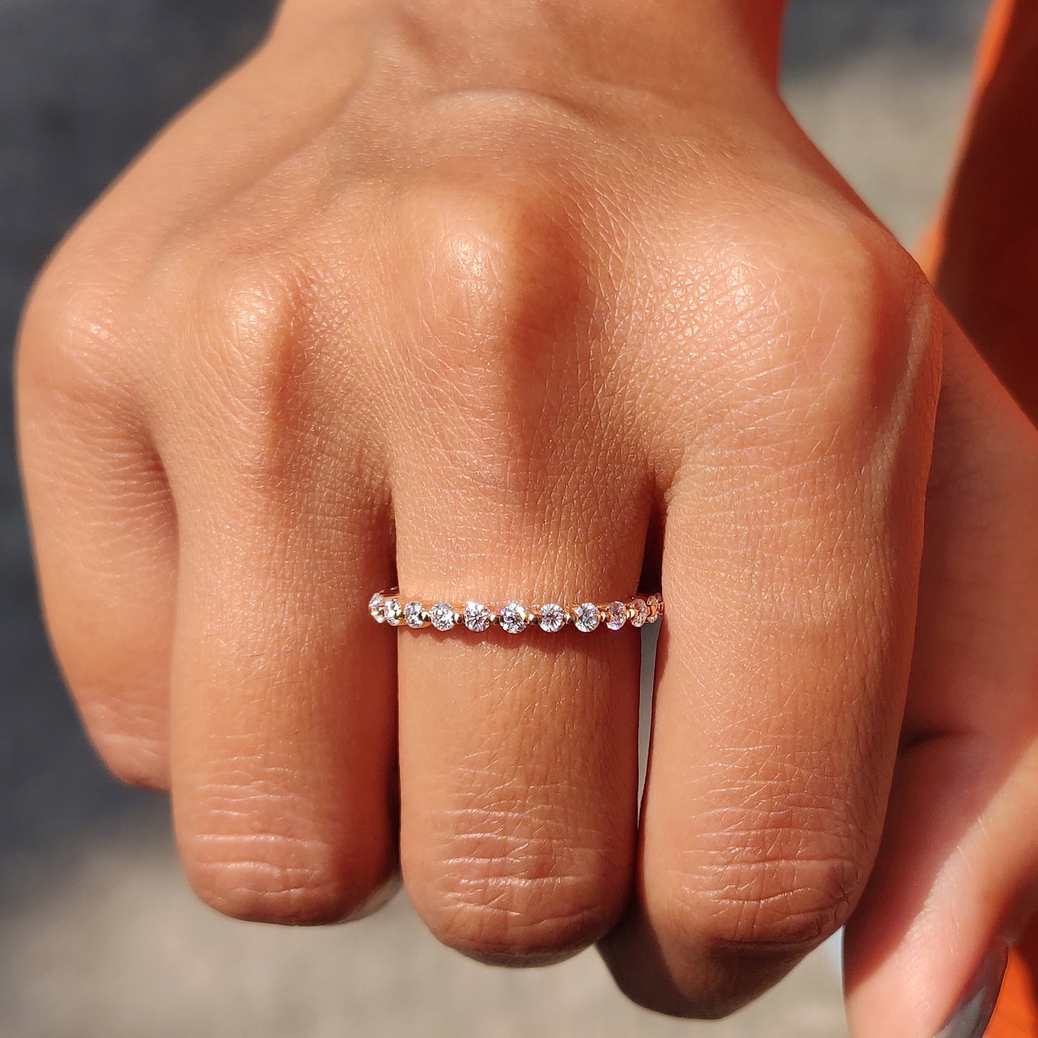Moissanite wedding band in rose gold, offering exceptional brilliance.