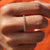 Eternity wedding band featuring brilliant round-cut diamonds in rose gold.