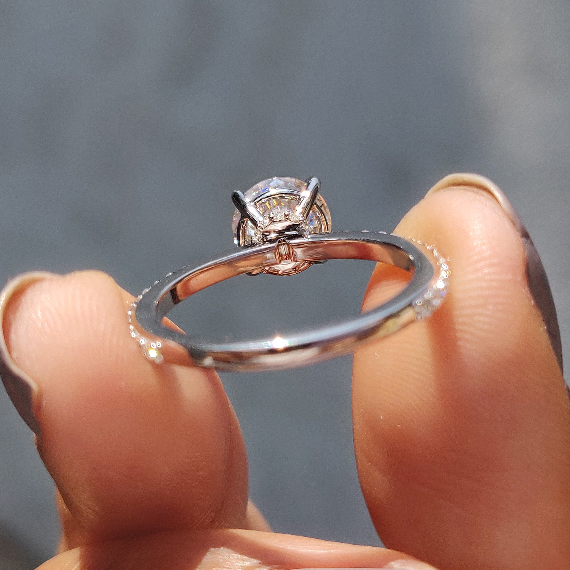 A round cut hidden halo pave setting creates a beautiful layered effect.
