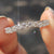 Moissanite half eternity band in white gold.