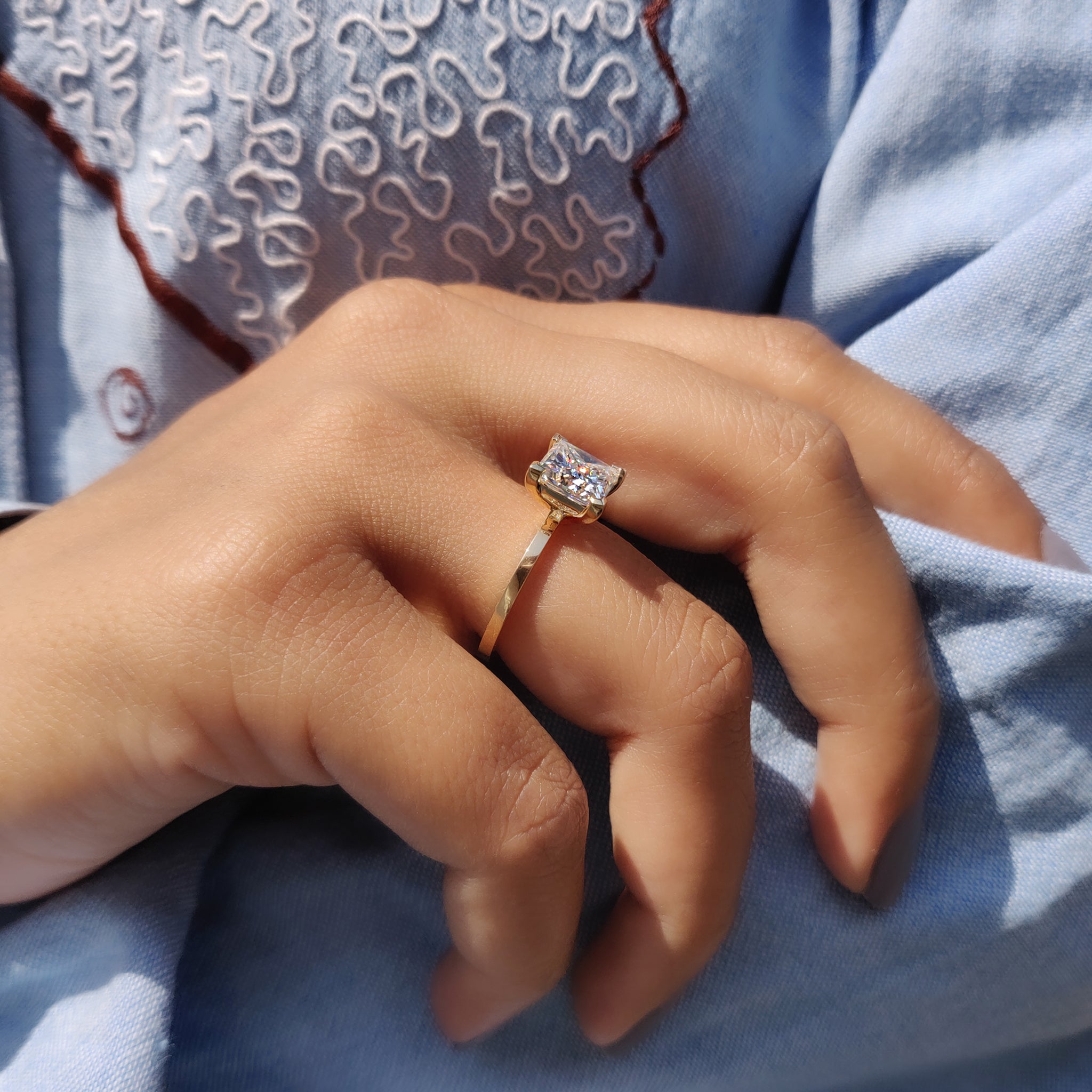 A simple engagement ring showcases timeless beauty and elegance.
