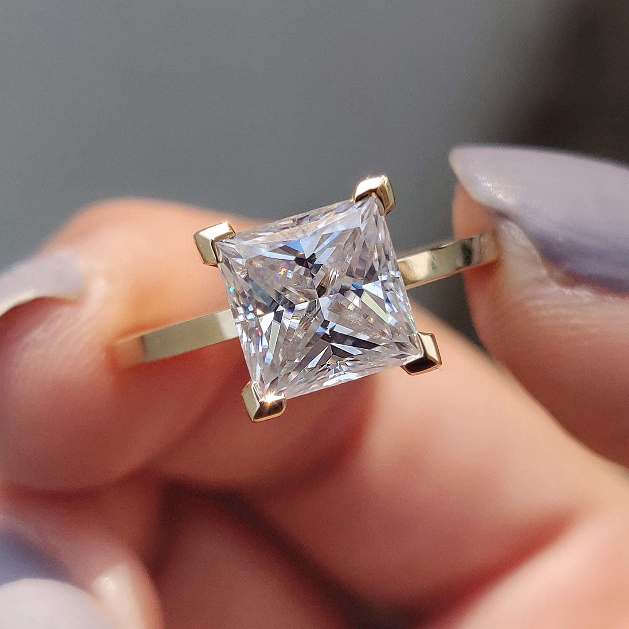 The moissanite yellow gold ring combines radiant brilliance with a warm, classic setting.
