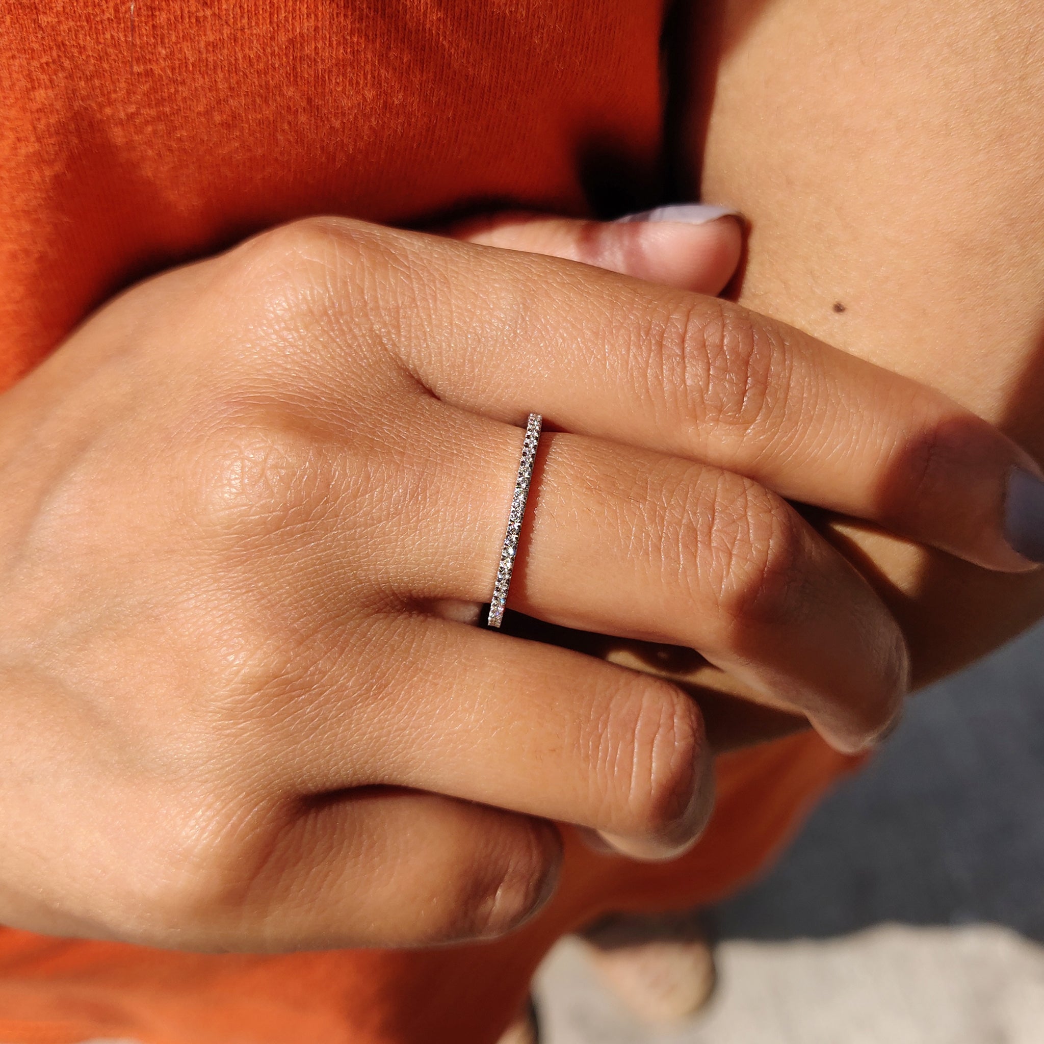 Simple wedding band featuring round moissanite.