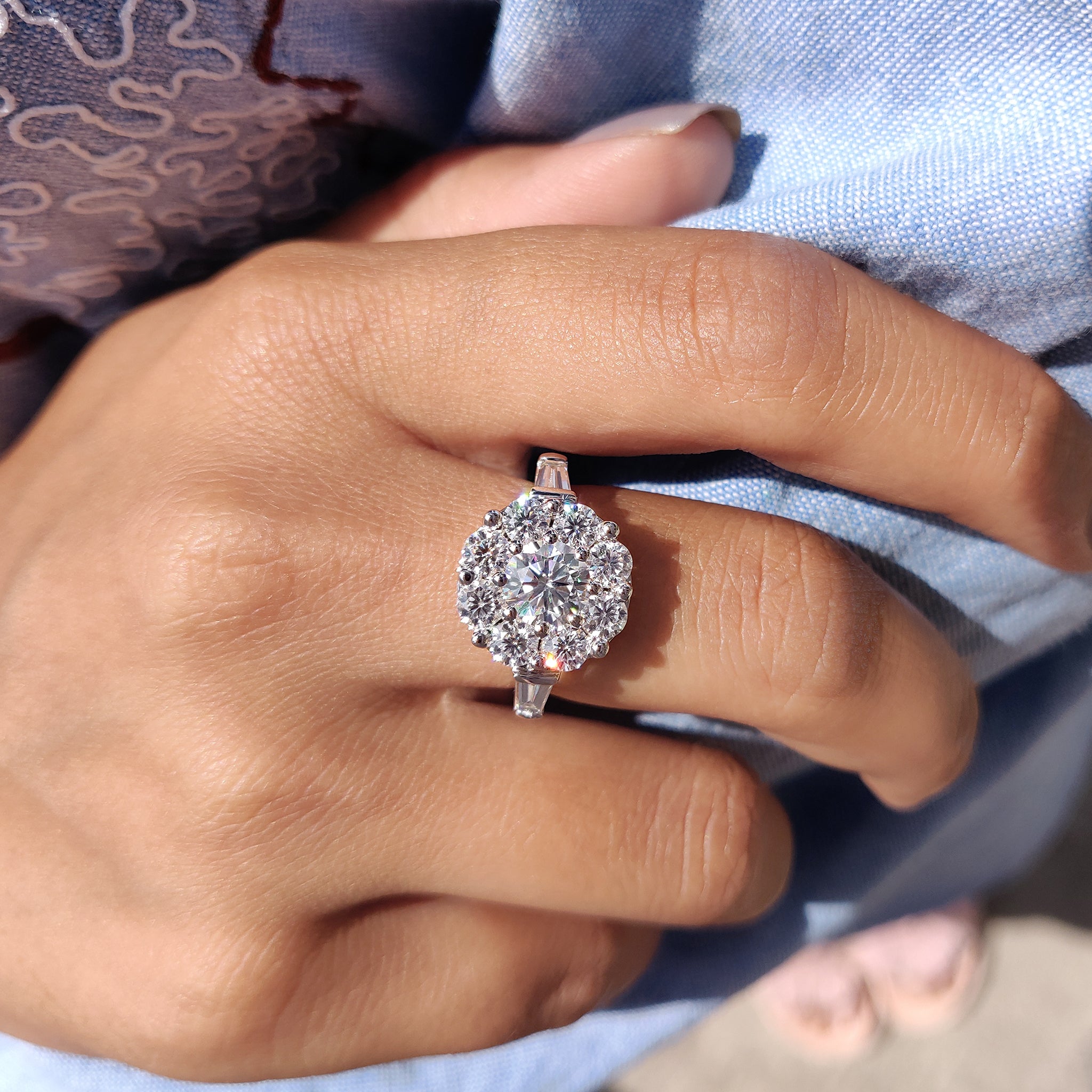 The round cut moissanite engagement ring offers brilliant sparkle.
