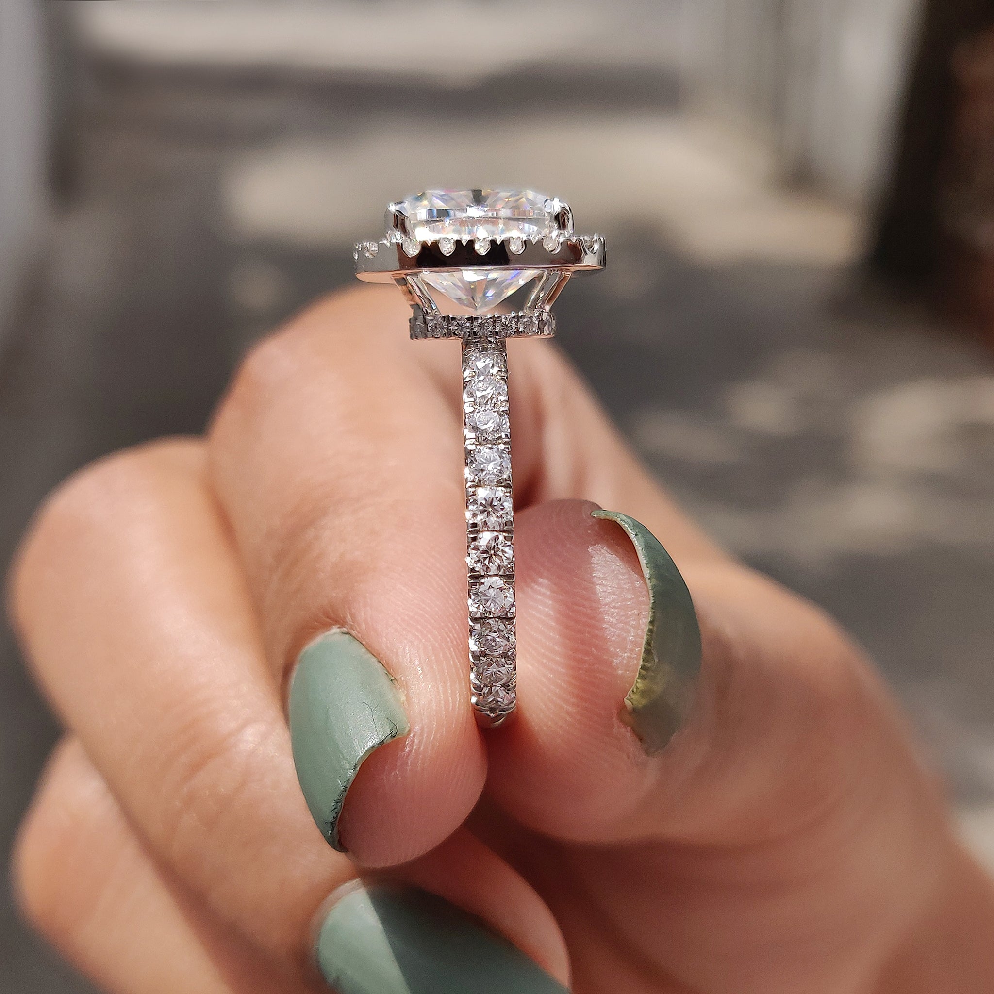A halo set ring highlights the center gem with a radiant glow.