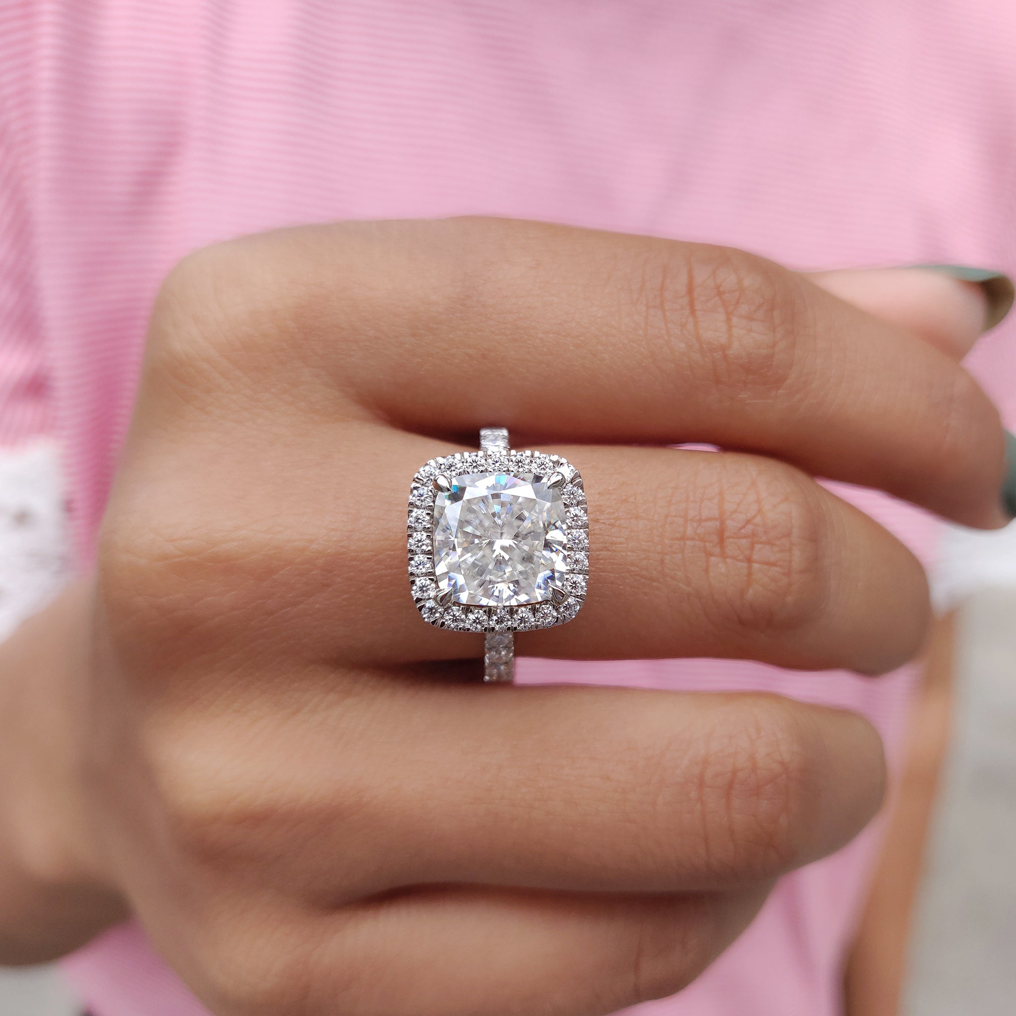 The moissanite halo ring shines with subtle elegance and sparkle.