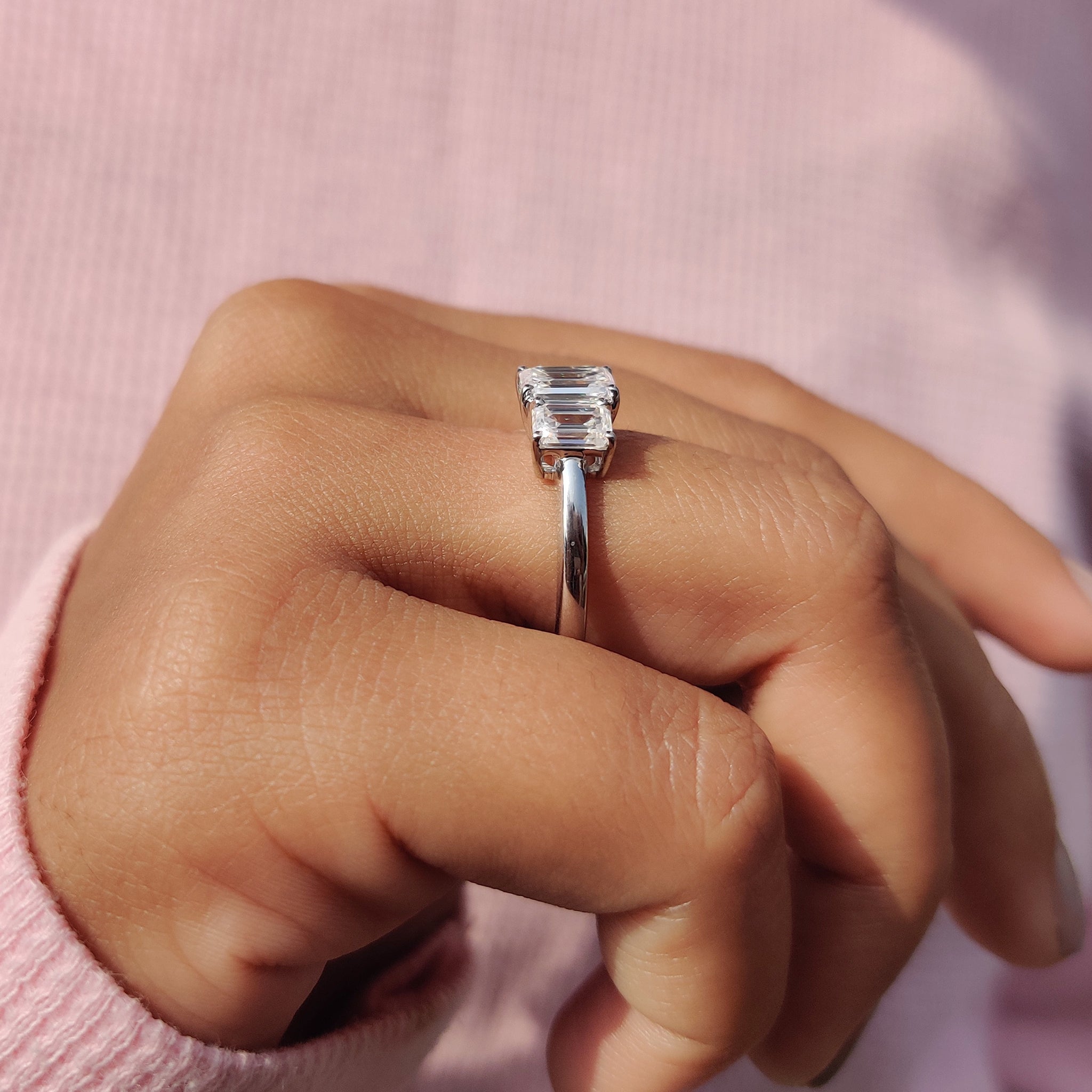 A stunning emerald cut moissanite ring shines with exceptional brilliance.
