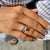 The emerald cut bezel ring securely frames the gemstone with sleek lines.