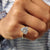 This Moissanite solitaire ring features a single stone for classic elegance.

