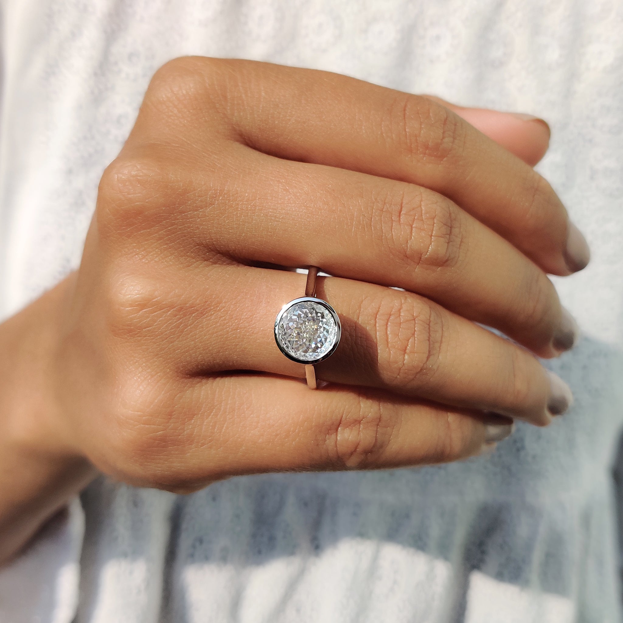 A solitaire moissanite ring offers brilliant sparkle with an eco-friendly twist.
