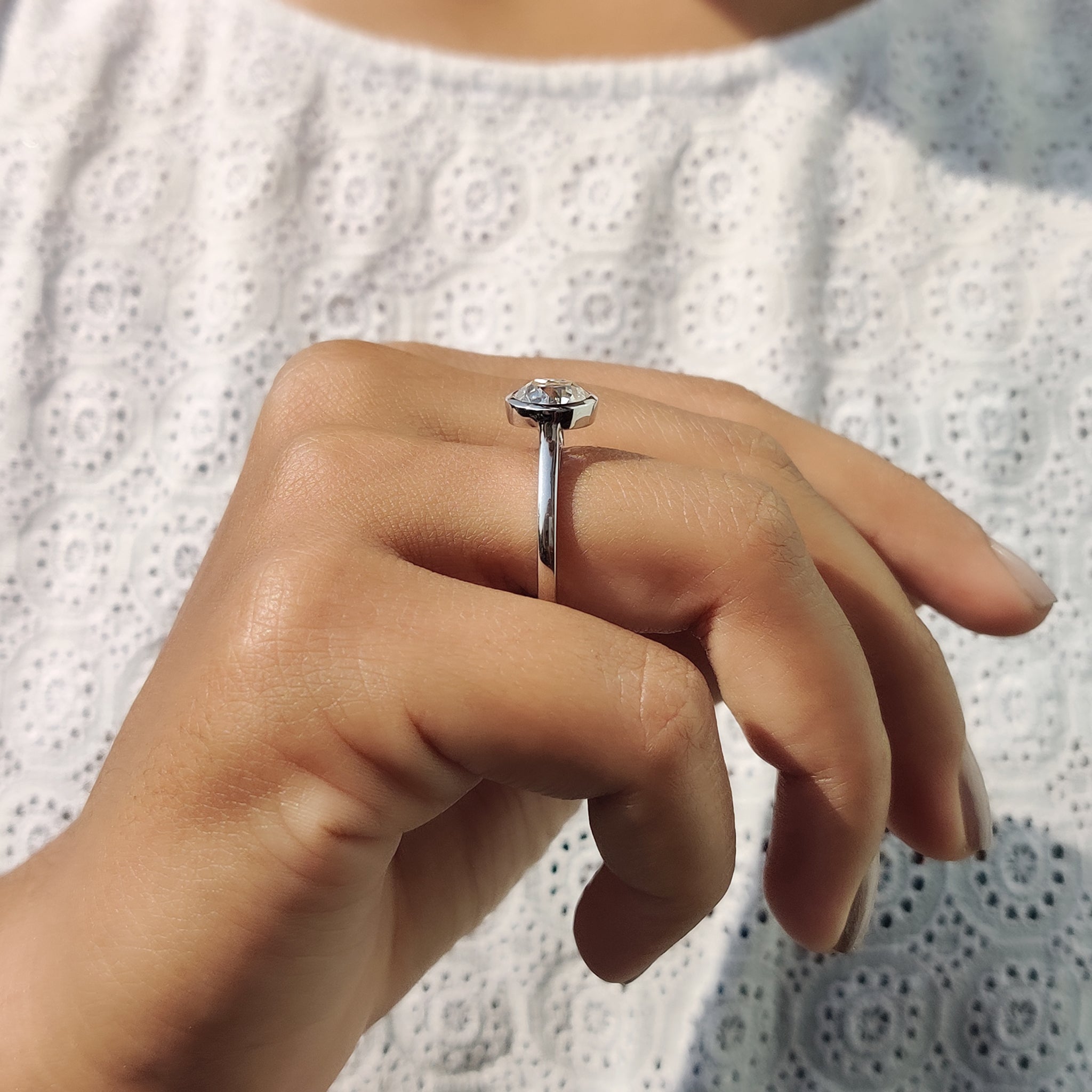 The white gold solitaire ring offers a refined, cool-toned finish.
