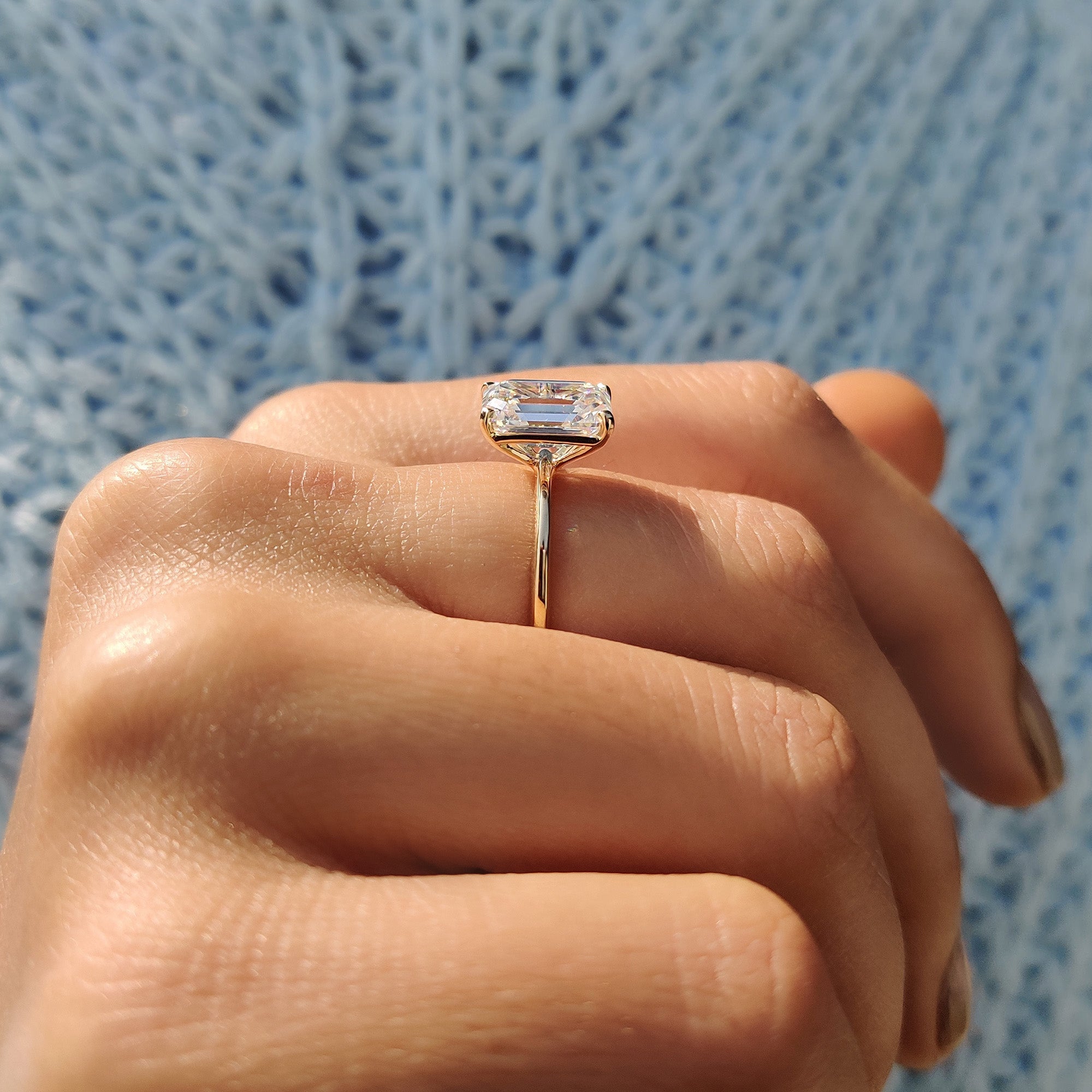 Emerald cut ring set in polished yellow gold.
