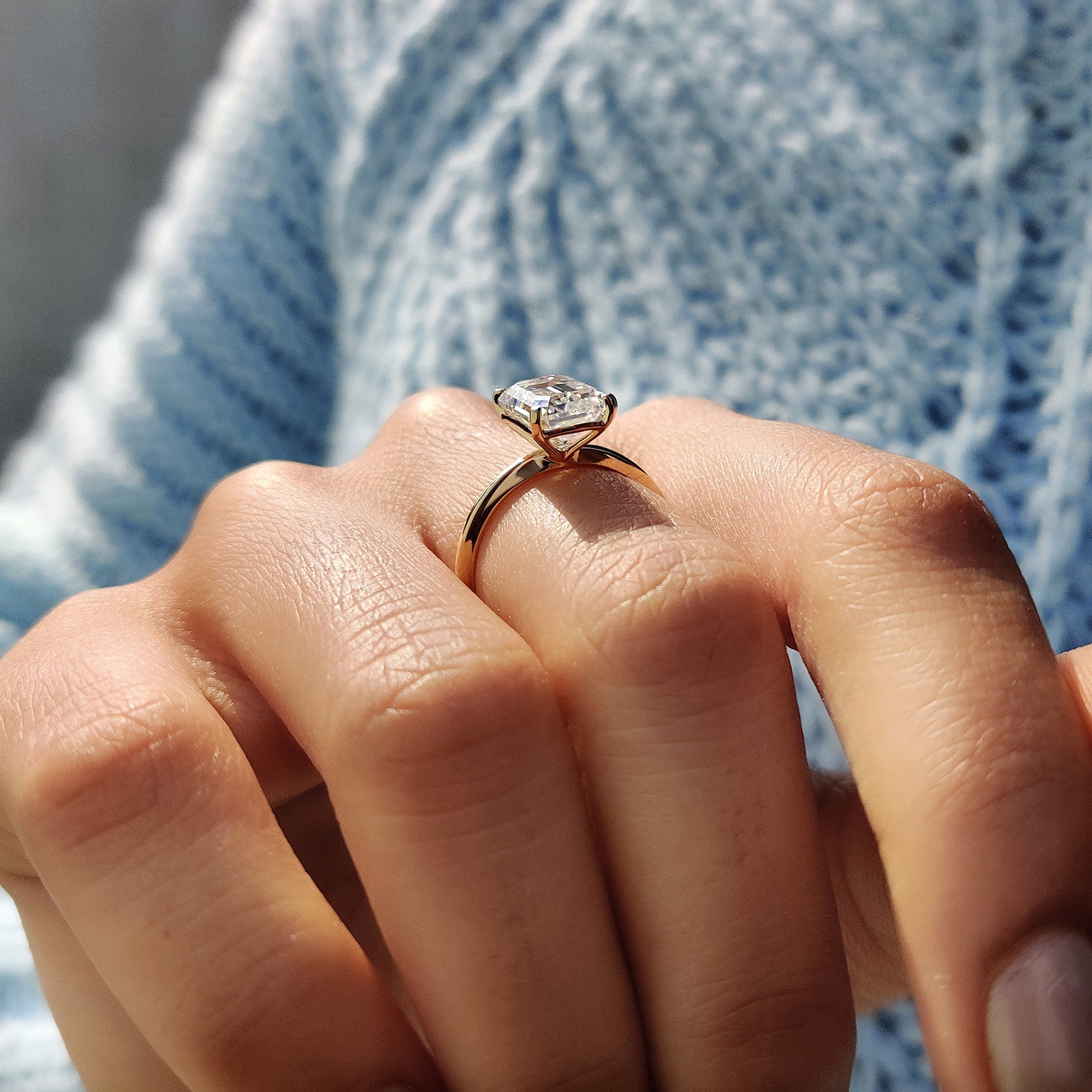 Yellow gold ring with emerald cut solitaire.

