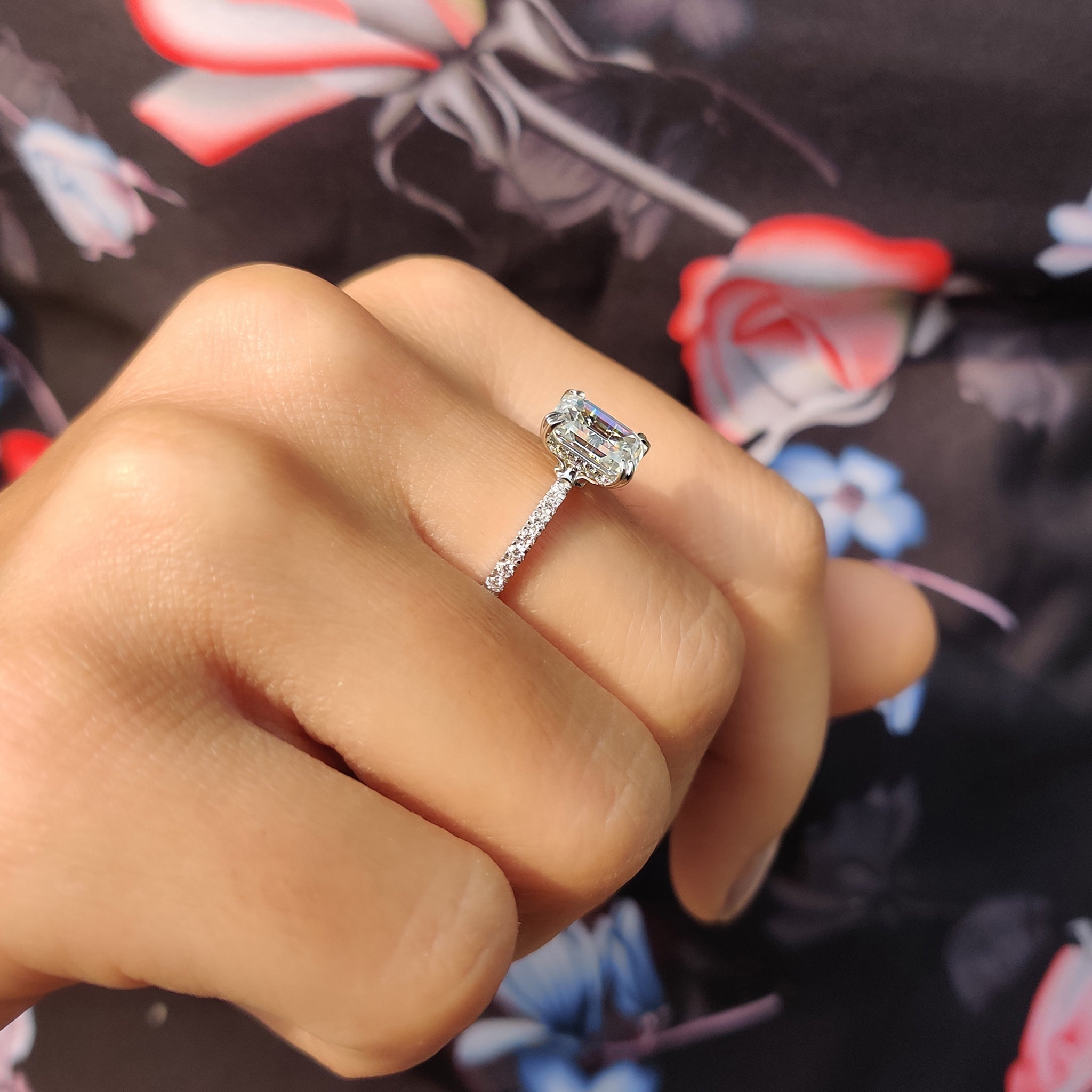 Handmade jewelry with a pave setting ring and emerald cut moissanite.