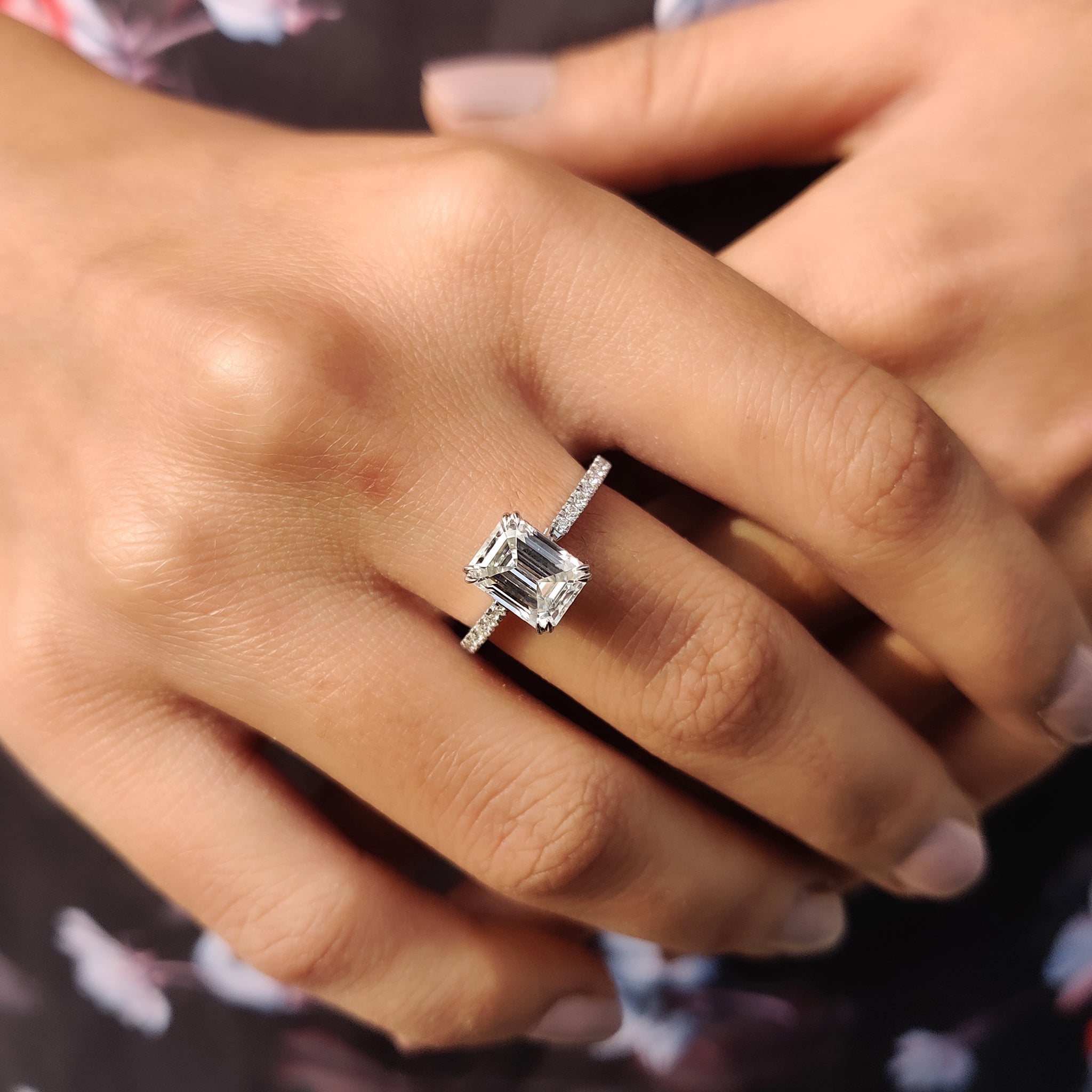 Handmade ring with a double claw prong setting and pave moissanite stone.
