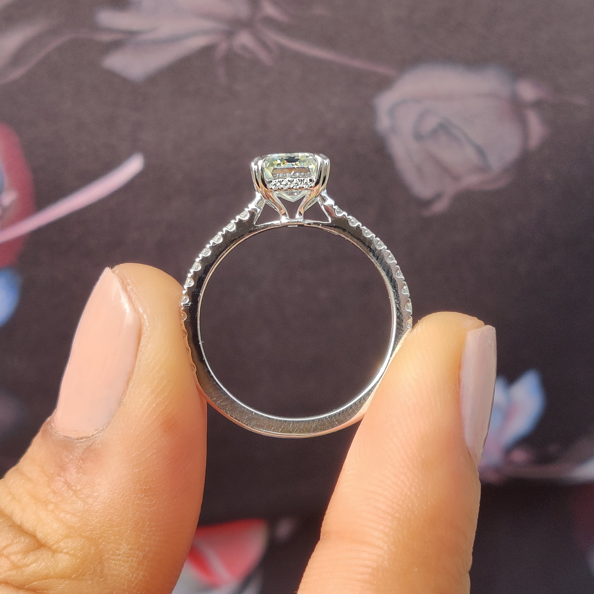 Emerald cut engagement ring with a pave setting for a moissanite stone.
