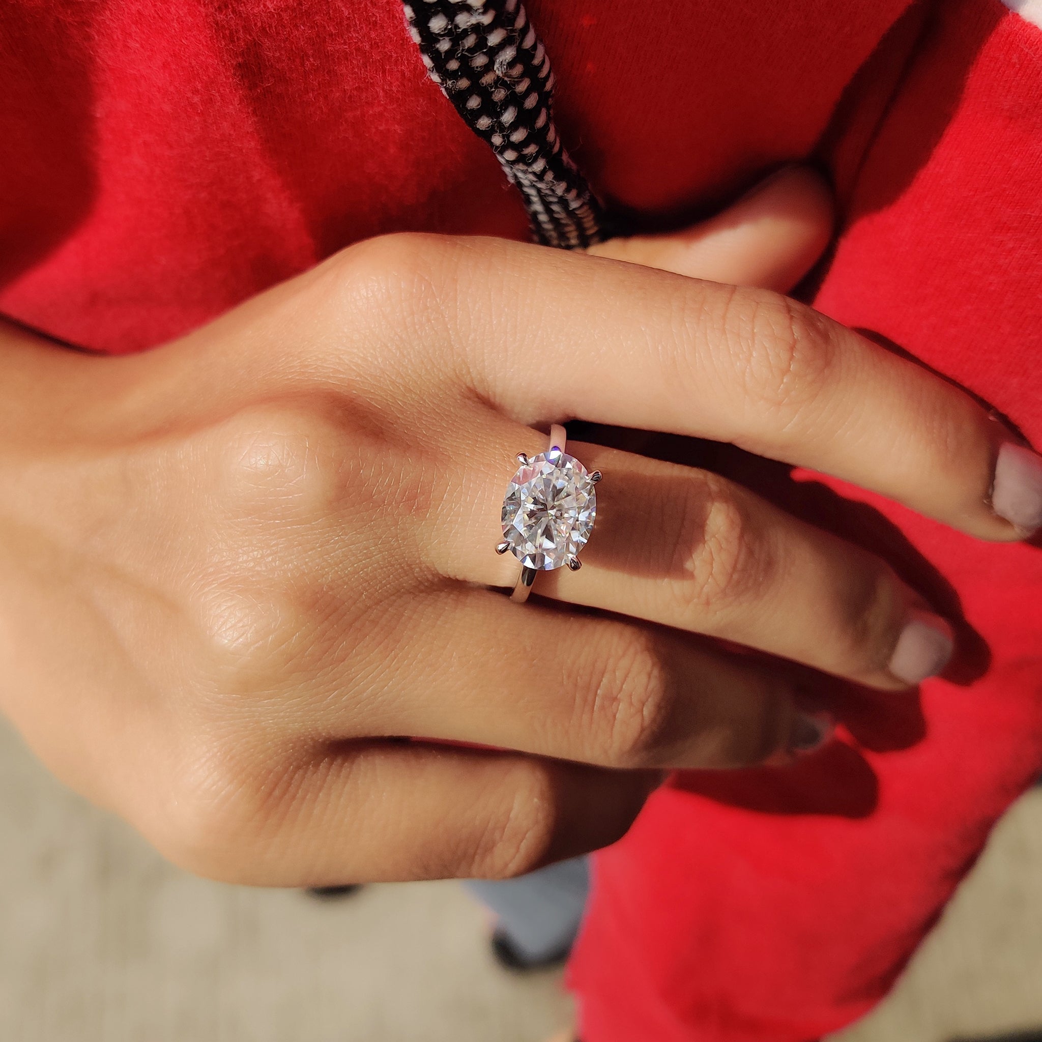 East west engagement ring featuring an oval cut stone.
