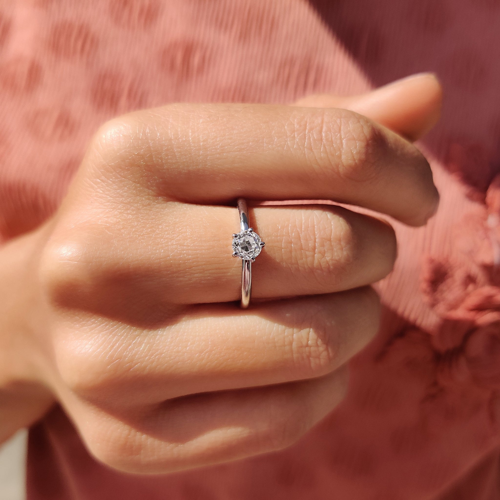 Round cut ring with prong setting in a moissanite ring design.