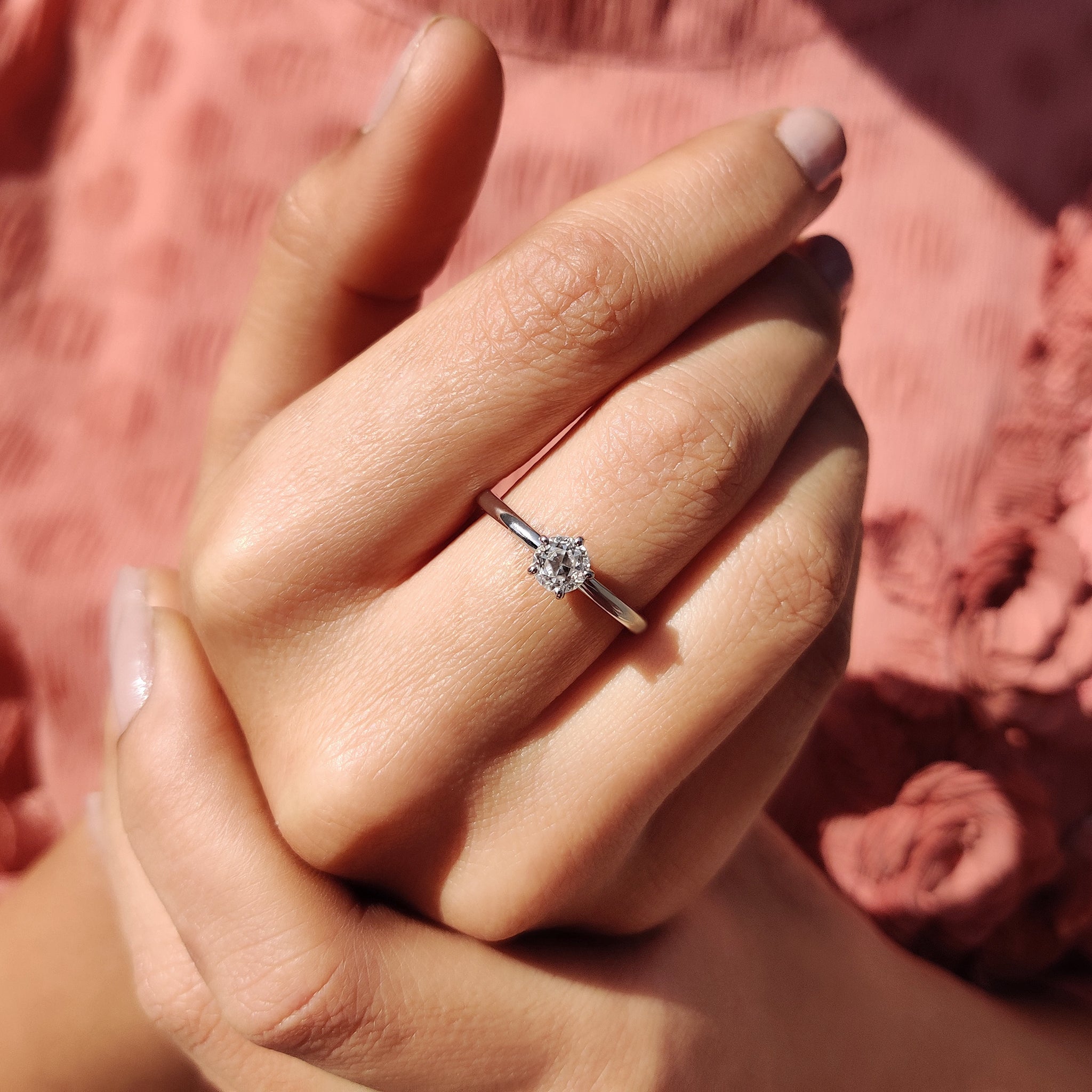 Moissanite ring in a minimalist round cut setting.